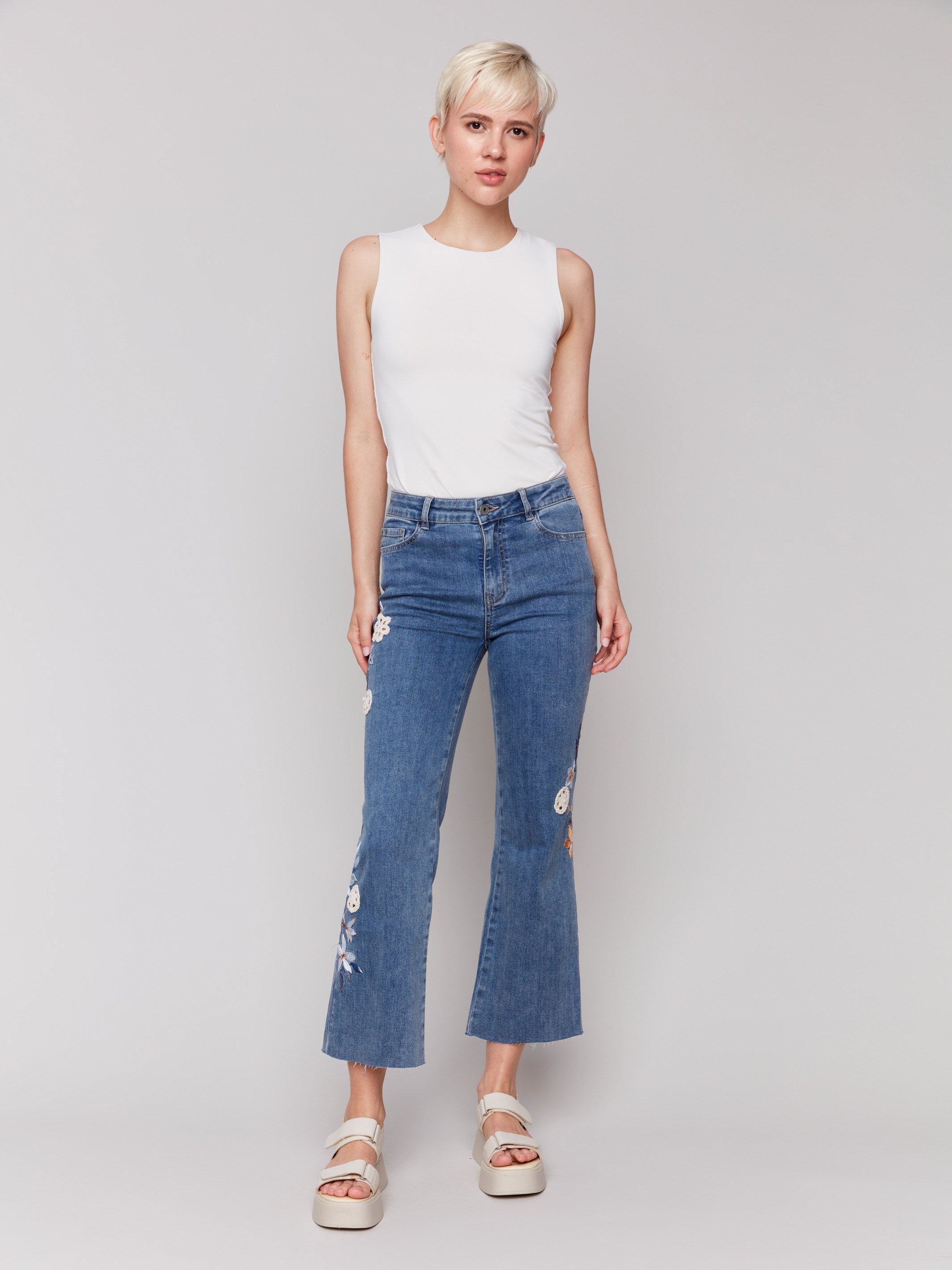 Medium blue jeans with flare leg fit and stretch denim material by Charlie B.