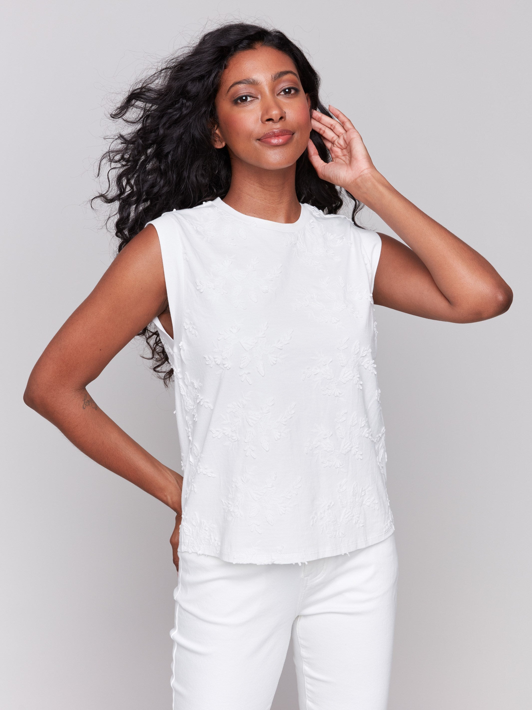 White cotton top with a crew neckline and floral embroidery by Charlie B.