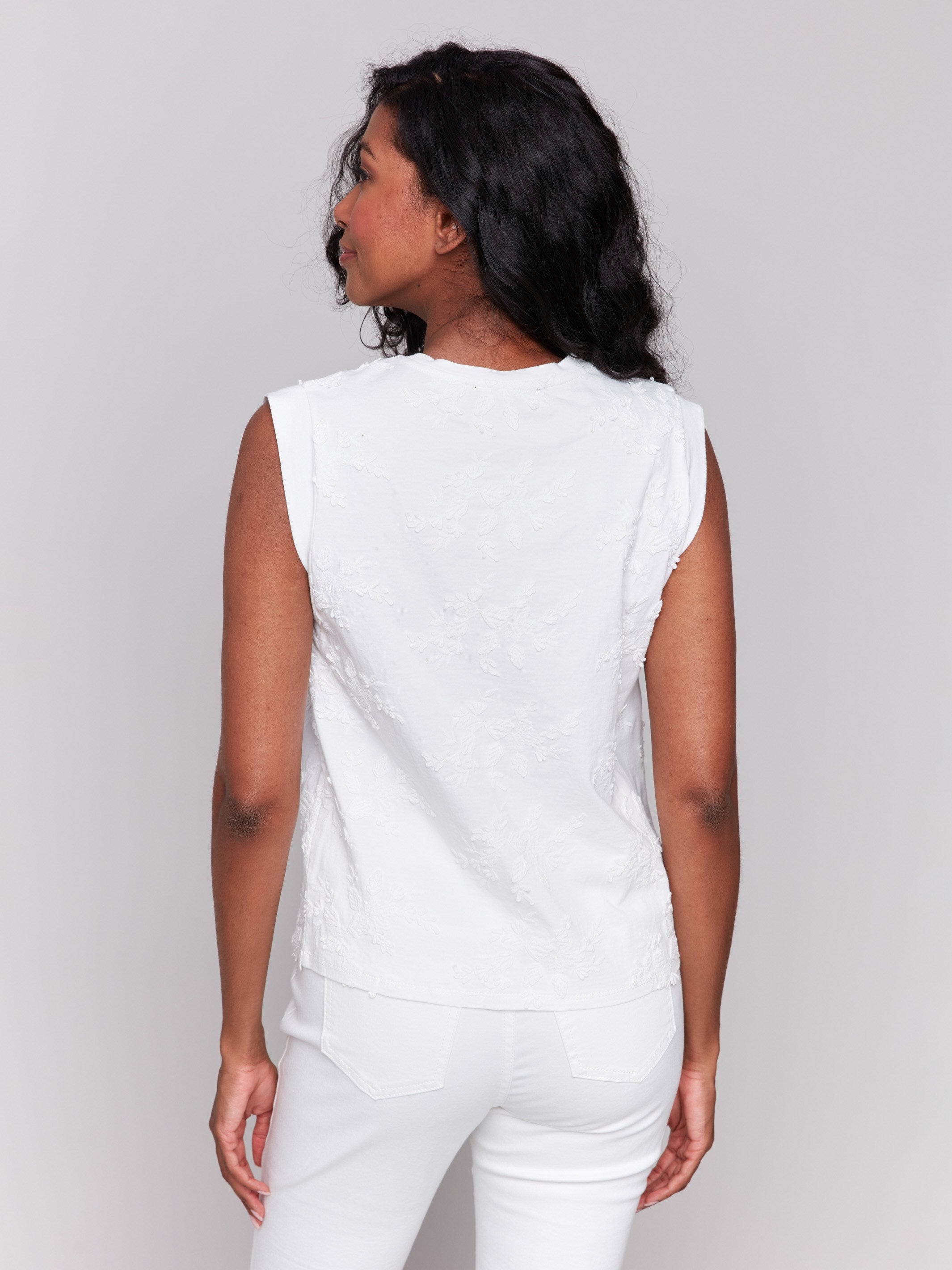 Elegant sleeveless top adorned with floral details by Charlie B.