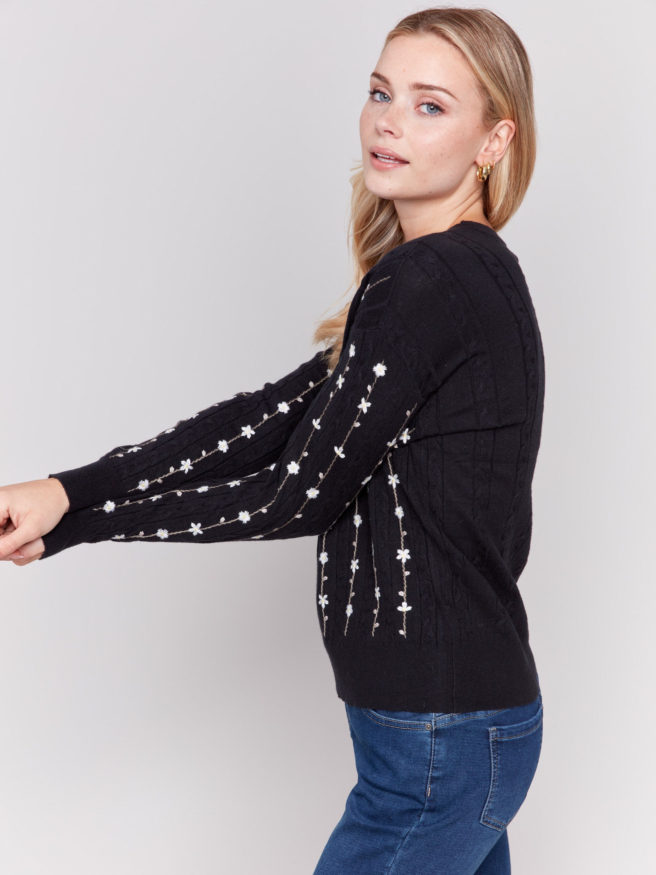 Black plushy knit sweater with floral embroidery, crew neck, and long sleeves by Charlie B.