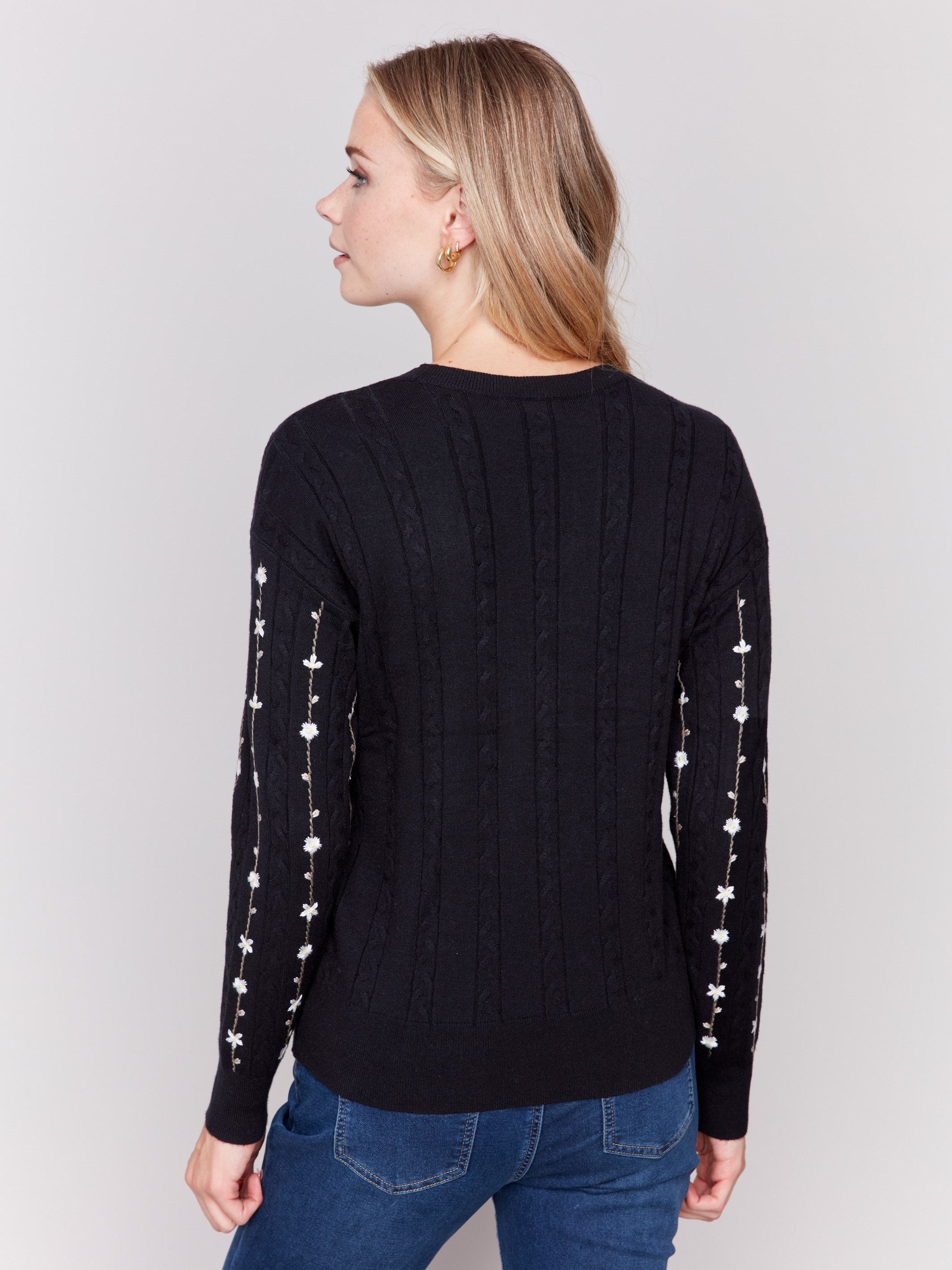 Black plushy knit sweater with floral embroidery, crew neck, and long sleeves by Charlie B.