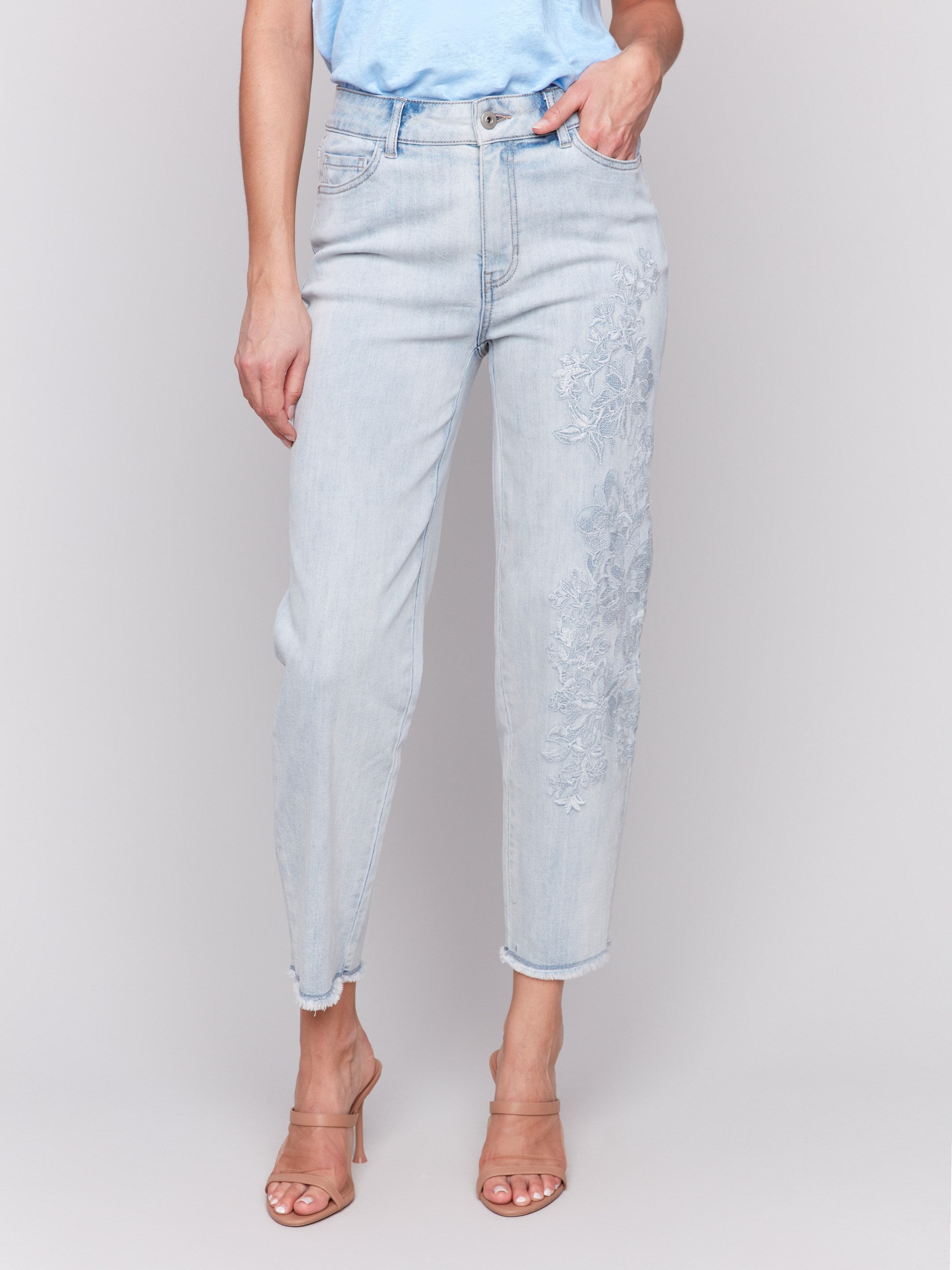 Cropped length bleach blue jeans featuring floral embroidery by Charlie B.