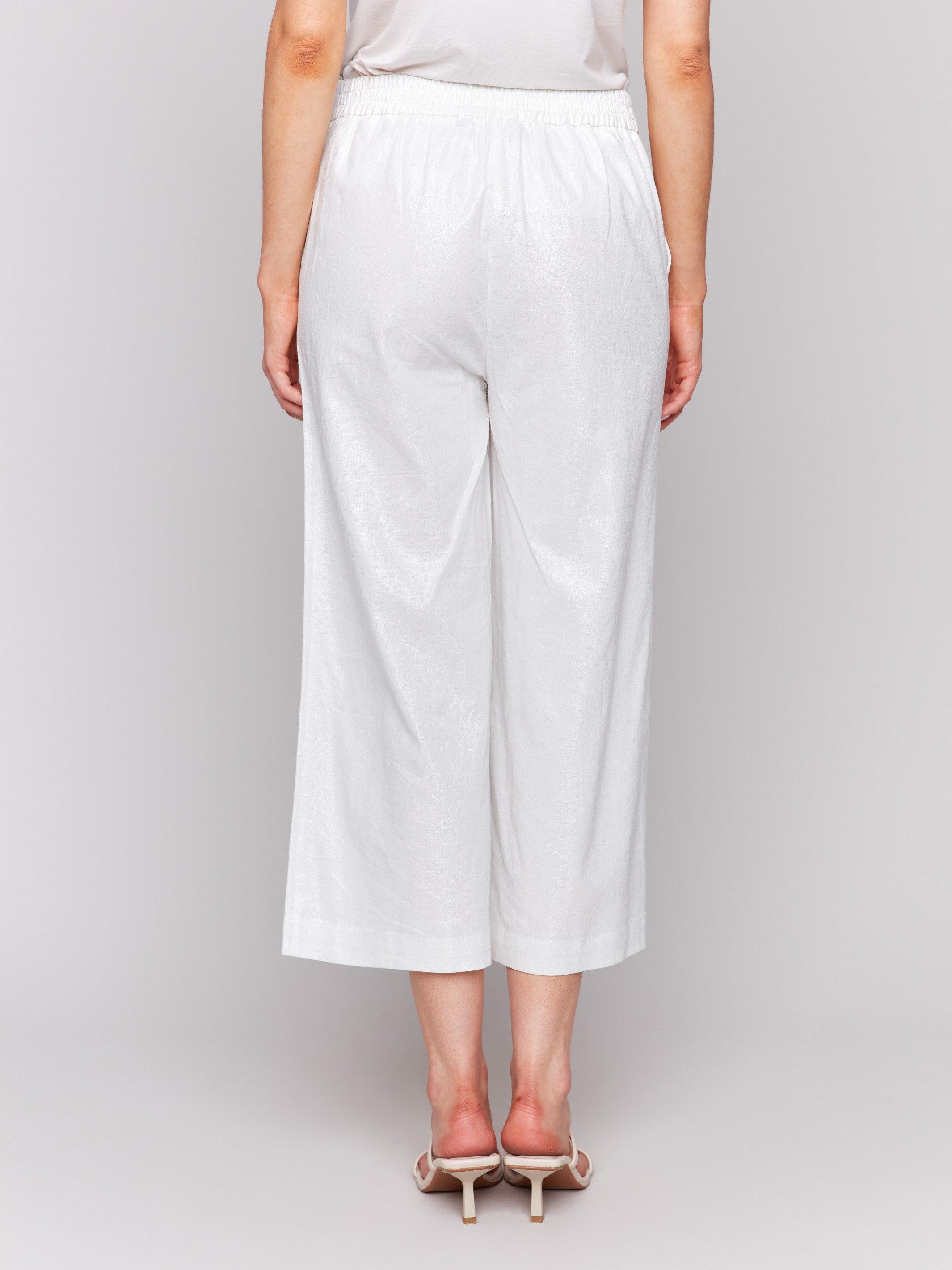 High-rise champagne pants showcasing an elegant wide leg by Charlie B.