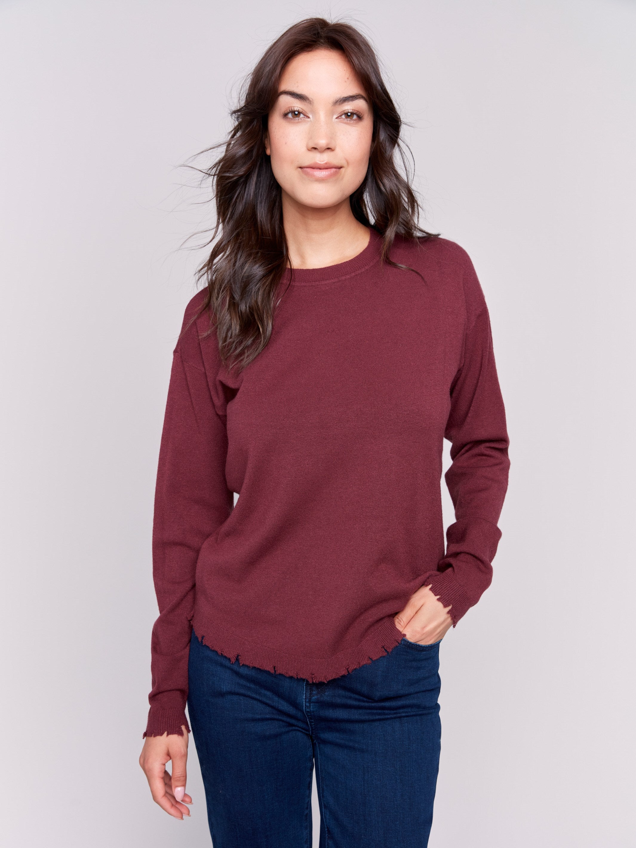 Cabernet red long-sleeve sweater with a crew neck and frayed rounded hem by Charlie B.