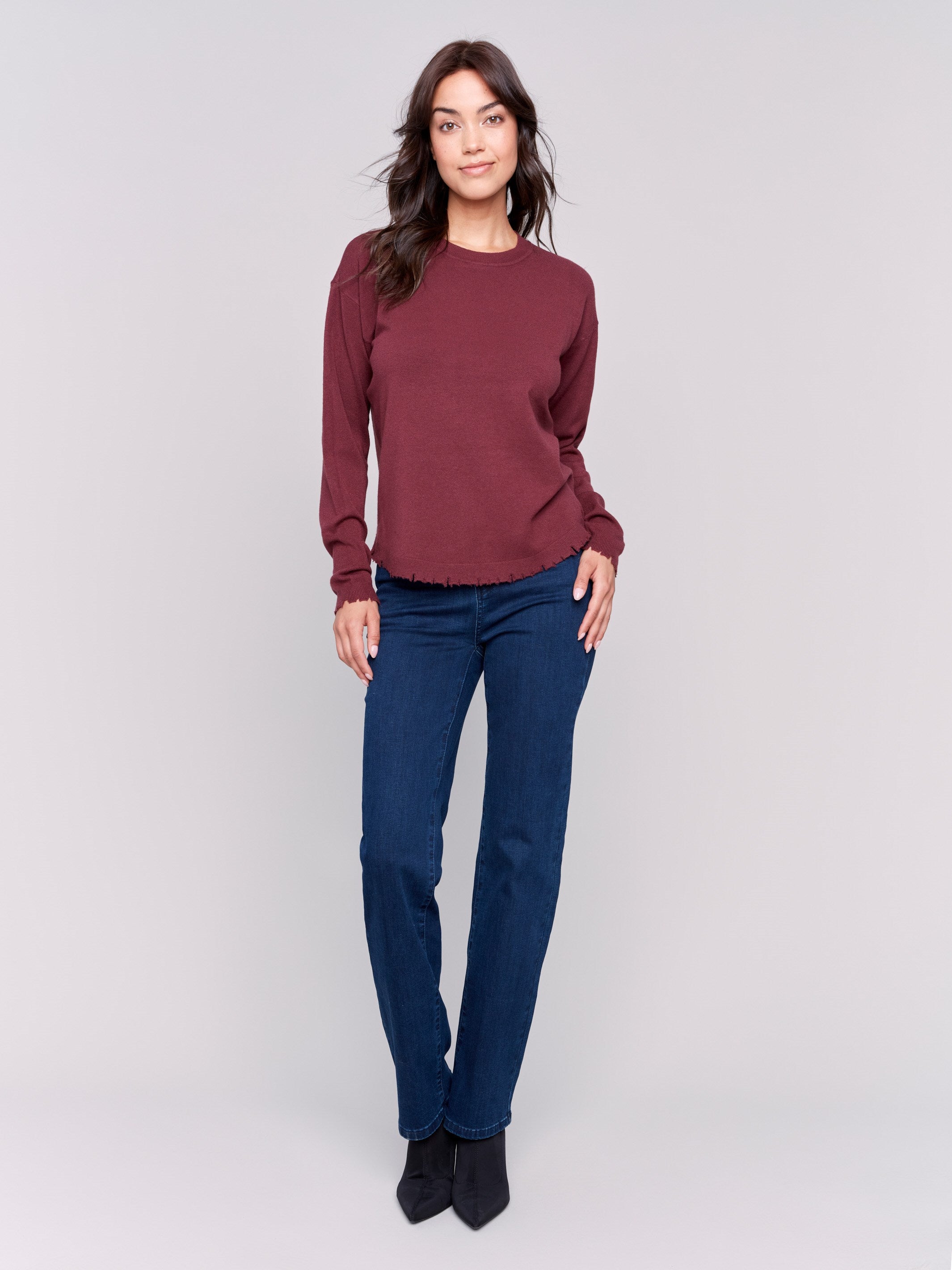 Cabernet red long-sleeve sweater with a crew neck and frayed rounded hem by Charlie B.