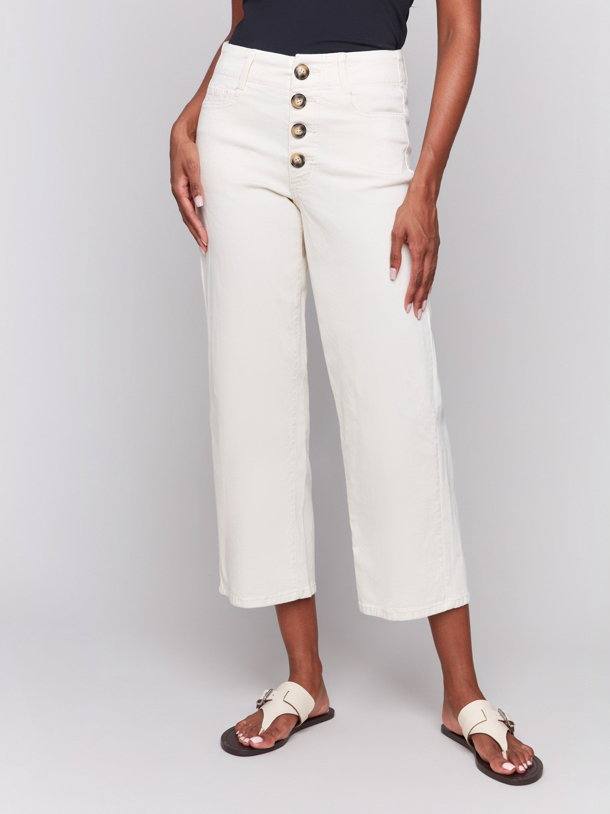 Natural color pants featuring a front button-fly closure in stretch twill fabric by Charlie B.