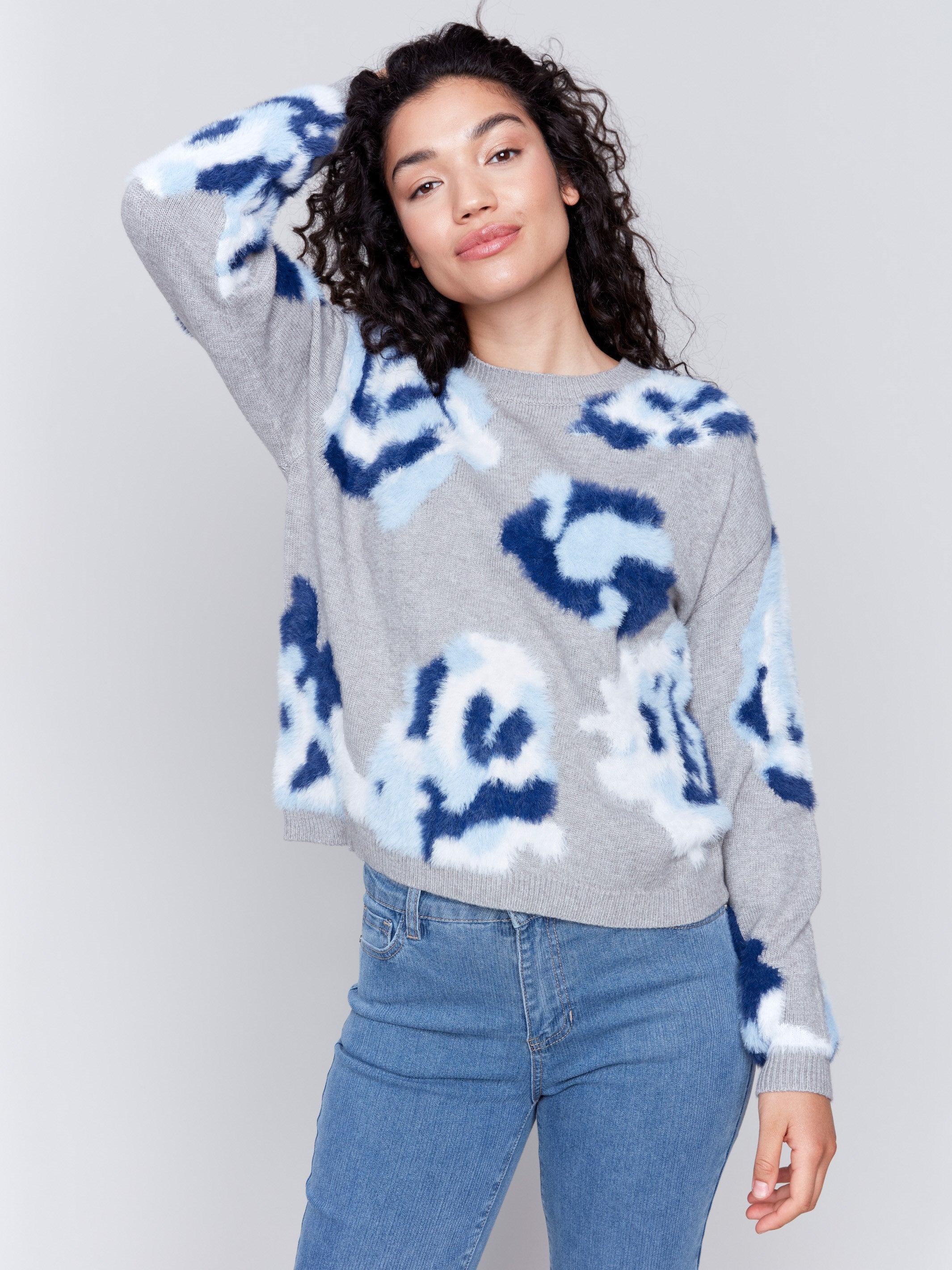 Light grey fuzzy jacquard knit sweater with a floral blue pattern, featuring a crew neck and drop-shoulder design by Charlie B.