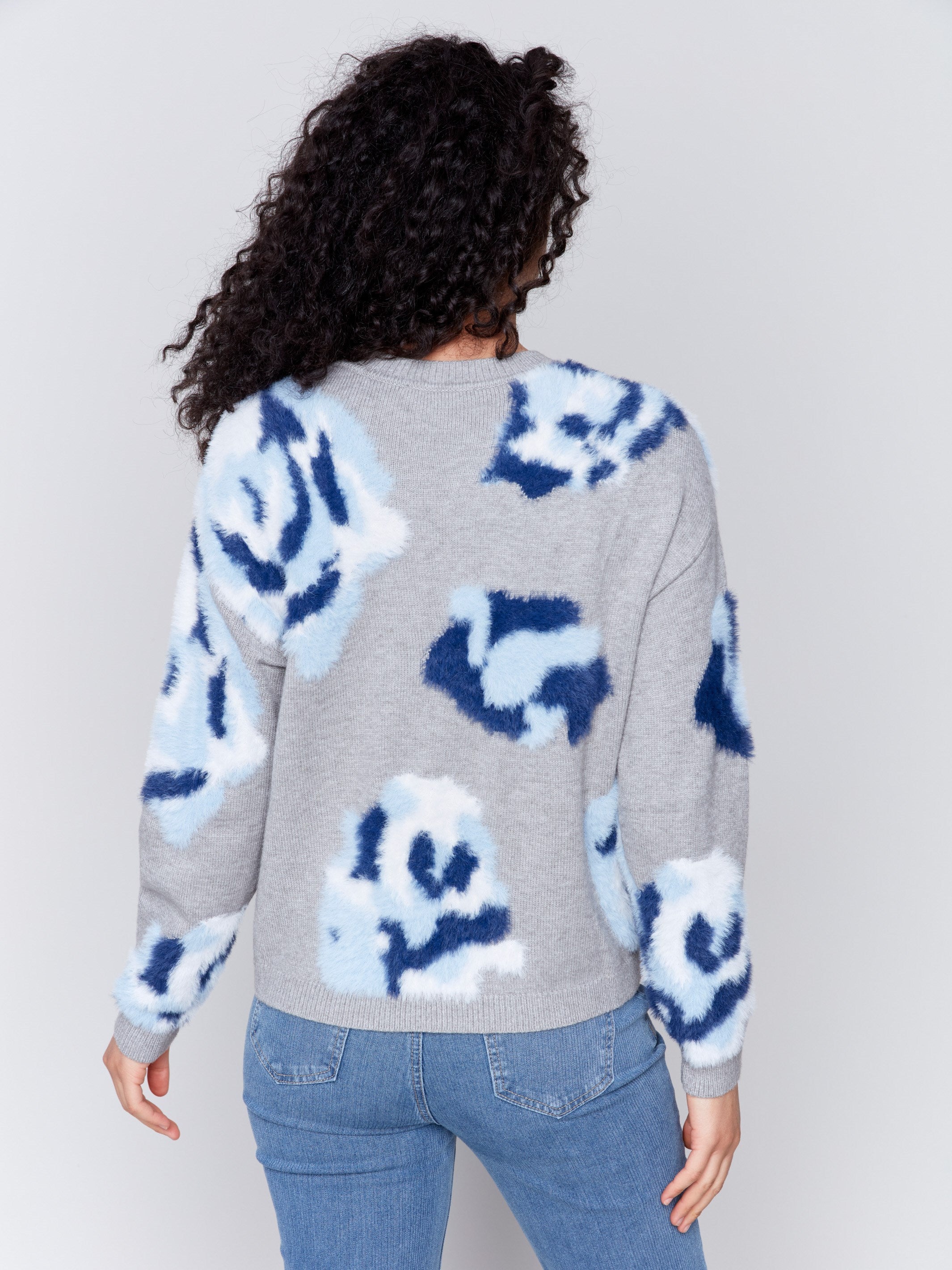 Light grey fuzzy jacquard knit sweater with a floral blue pattern, featuring a crew neck and drop-shoulder design by Charlie B.