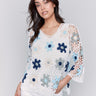 Blue floral crochet top with a V-neck and detailed 3/4 sleeves by Charlie B.