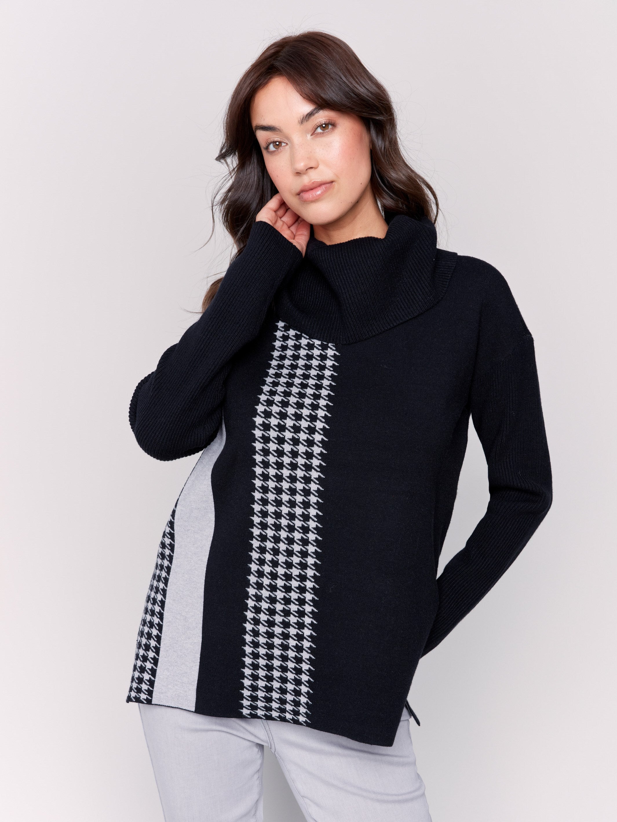 Black sweater with a houndstooth stripe, featuring a cowl neck and side slit by Charlie B.