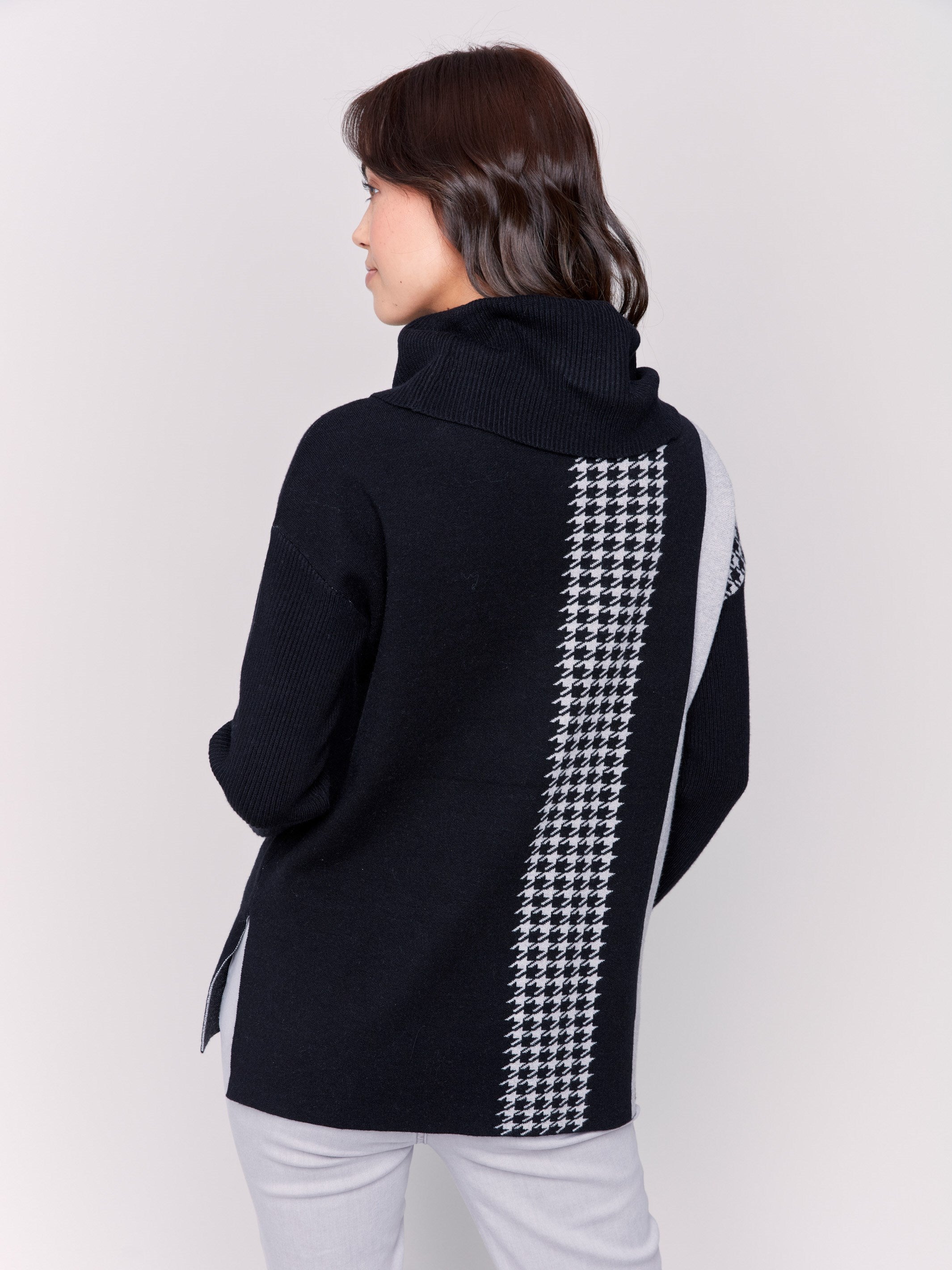 Black sweater with a houndstooth stripe, featuring a cowl neck and side slit by Charlie B.