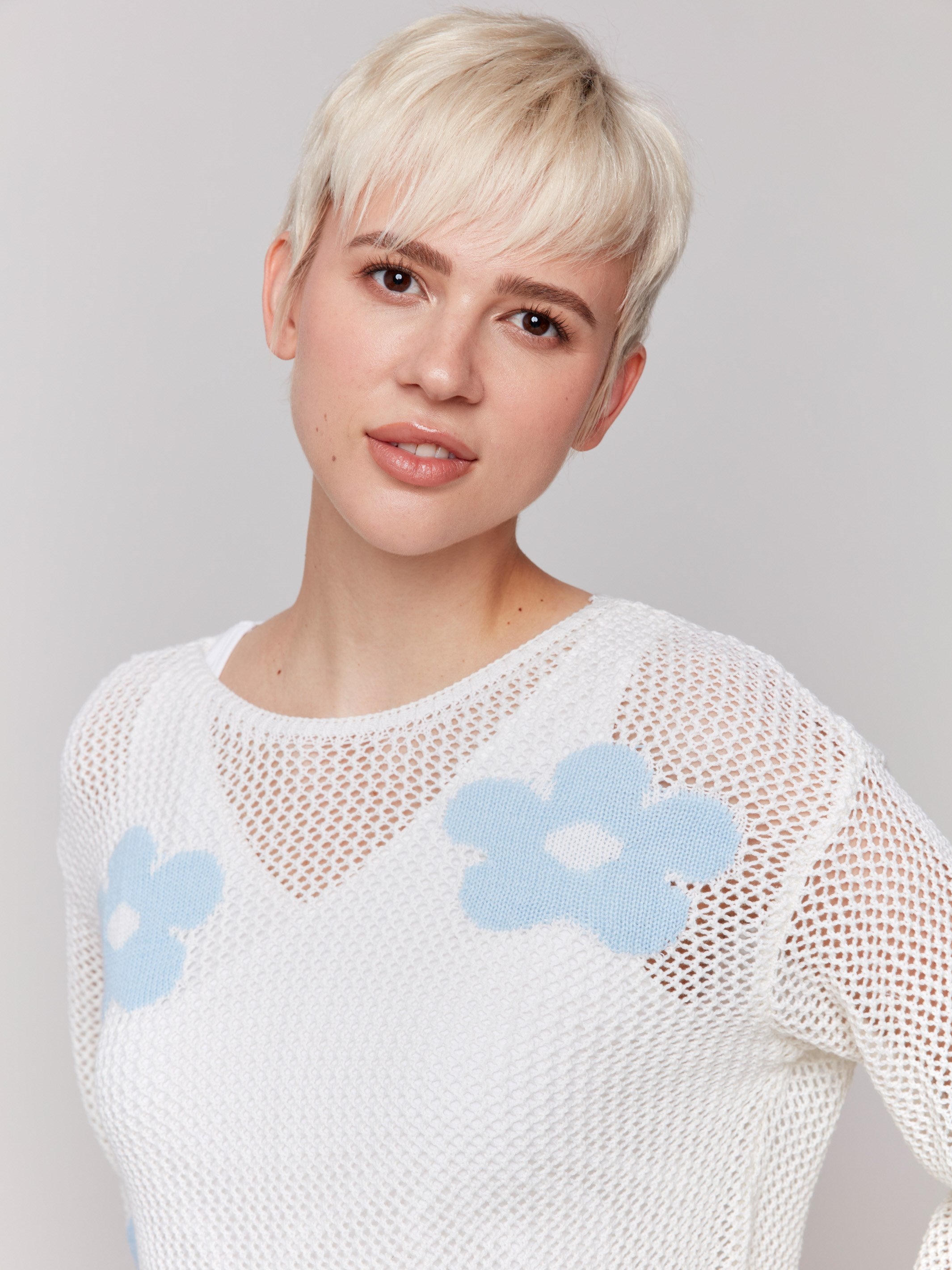 Crochet sweater featuring light blue floral pattern, perfect for any occasion by Charlie B.