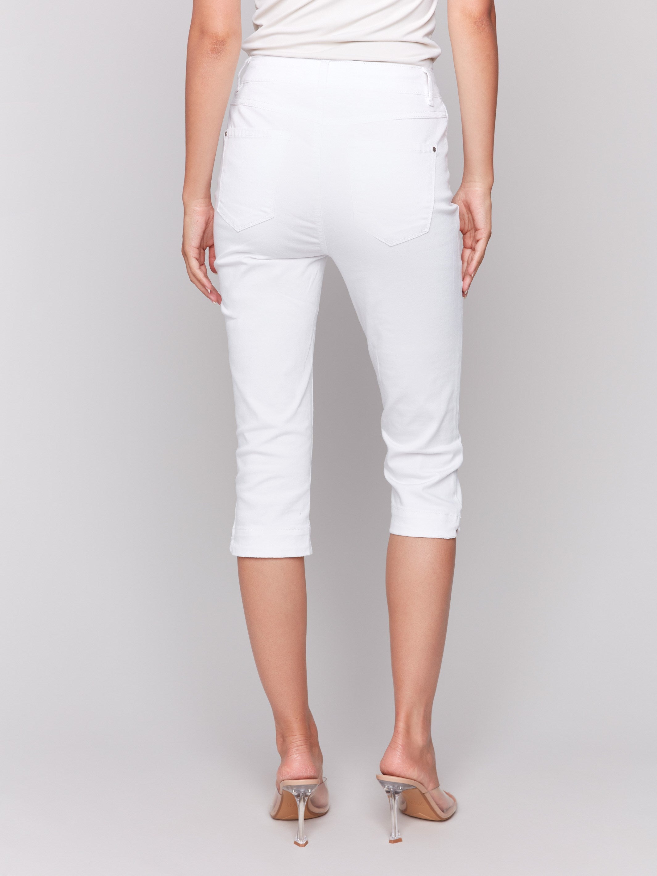 Knee-high white capris crafted from stretch twill fabric by Charlie B.