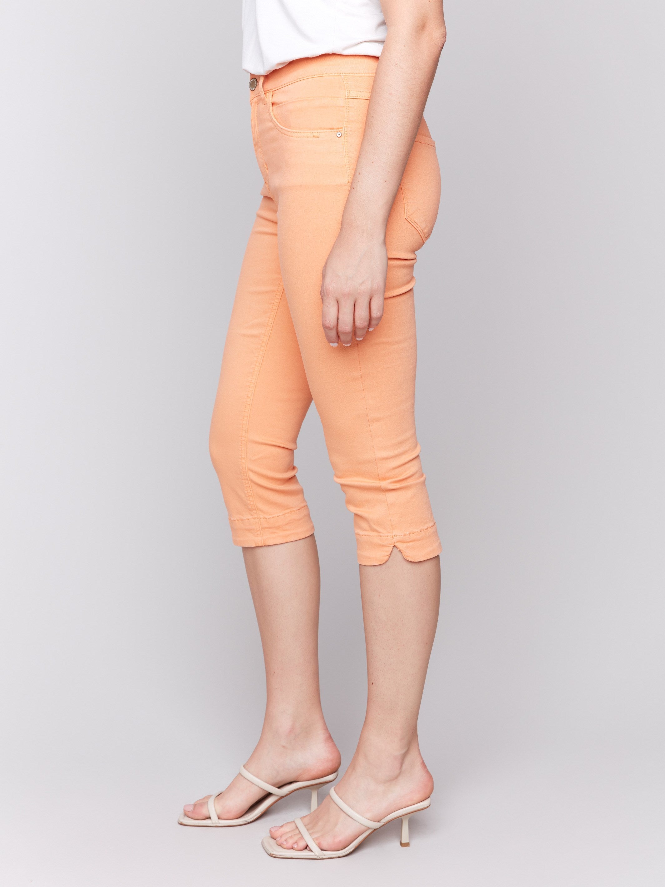 Slim-leg capri pants in papaya color made from stretch twill fabric by Charlie B.