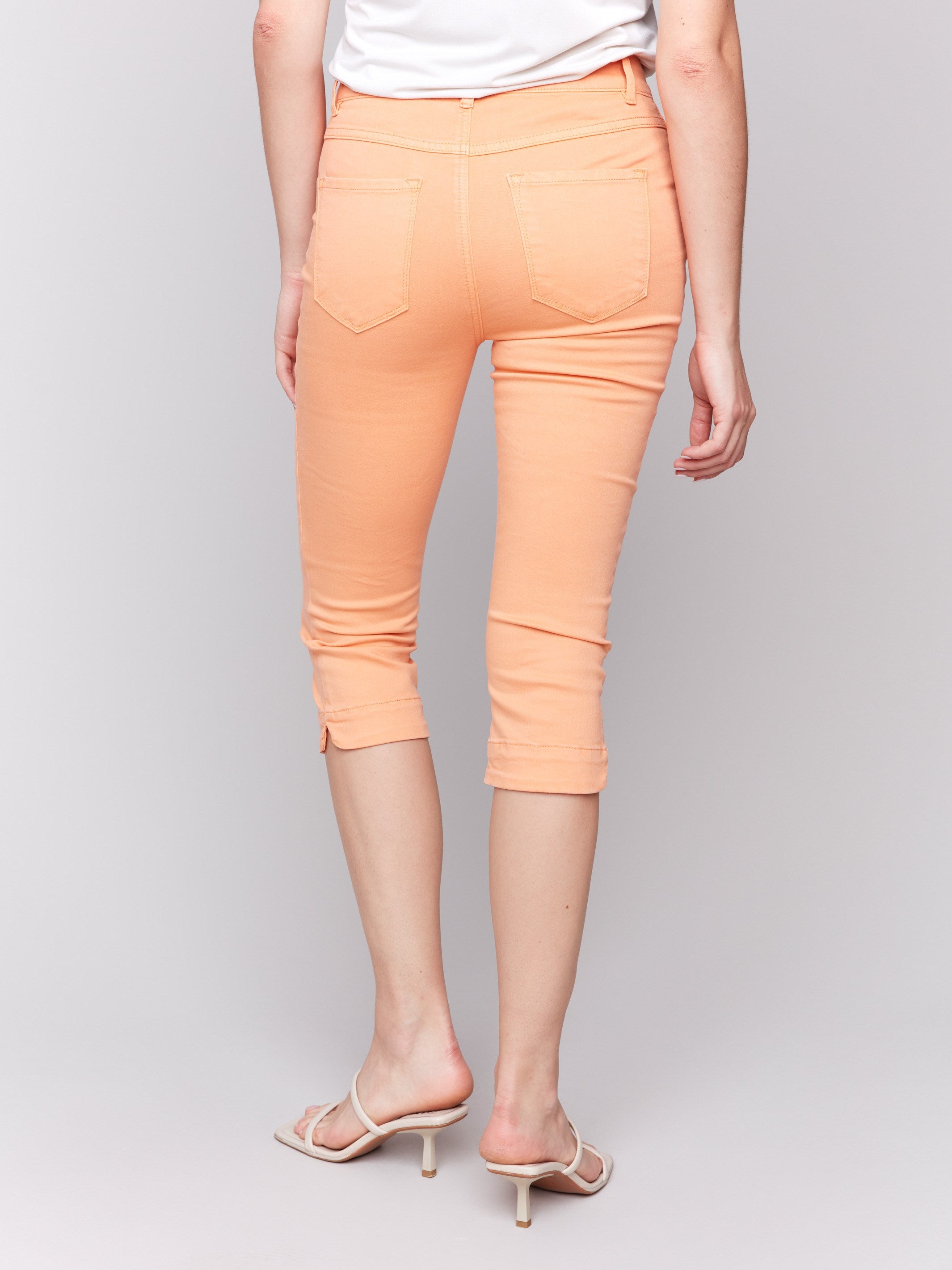 Knee-high capris in papaya with classic five pockets and regular rise fit by Charlie B.