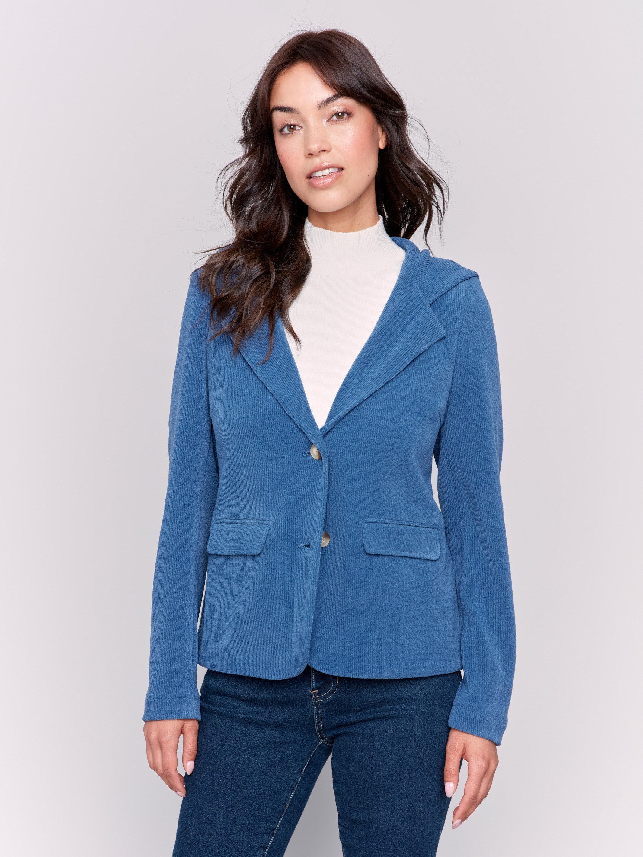 Light blue corduroy blazer with a hood, featuring two button closure, tailored fit, and two front flap pockets by Charlie B.