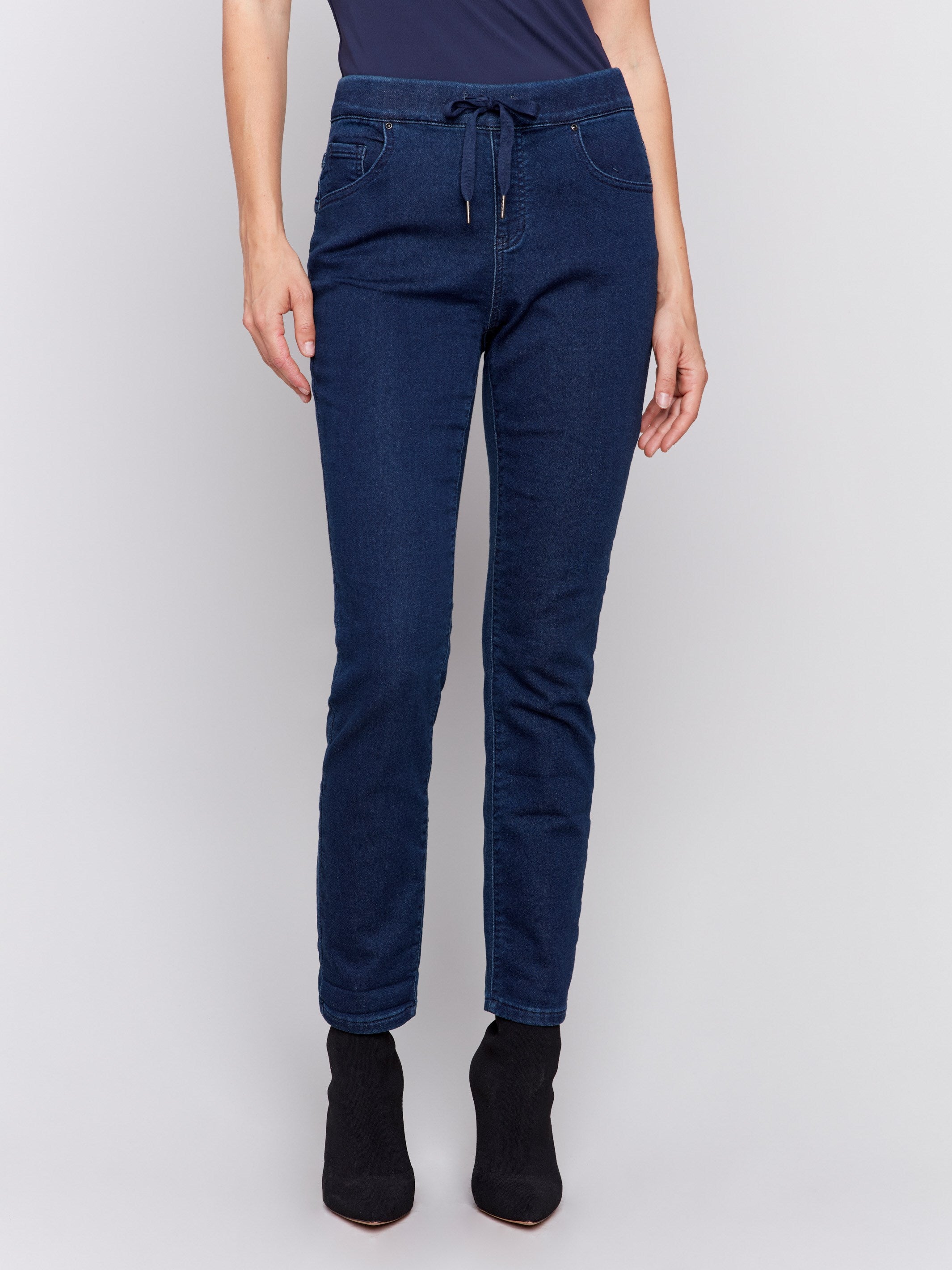 Blue-black knit denim jogger pants with a slim-leg fit, featuring an elastic waistband and front and back pockets by Charlie B.