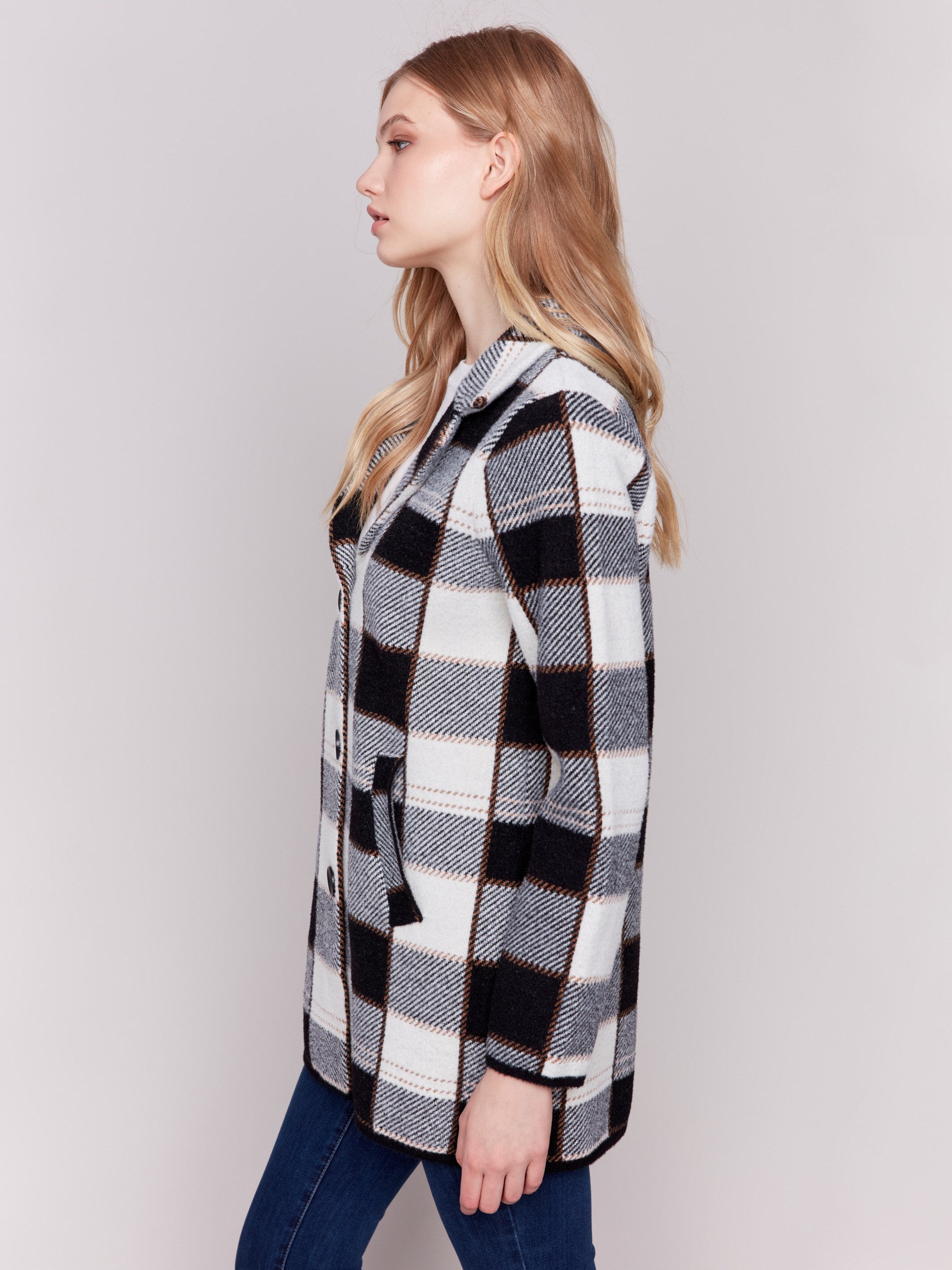 Women's plaid coat in black and white with a lapel notch collar, full button closure, and side welt pockets by Charlie B.