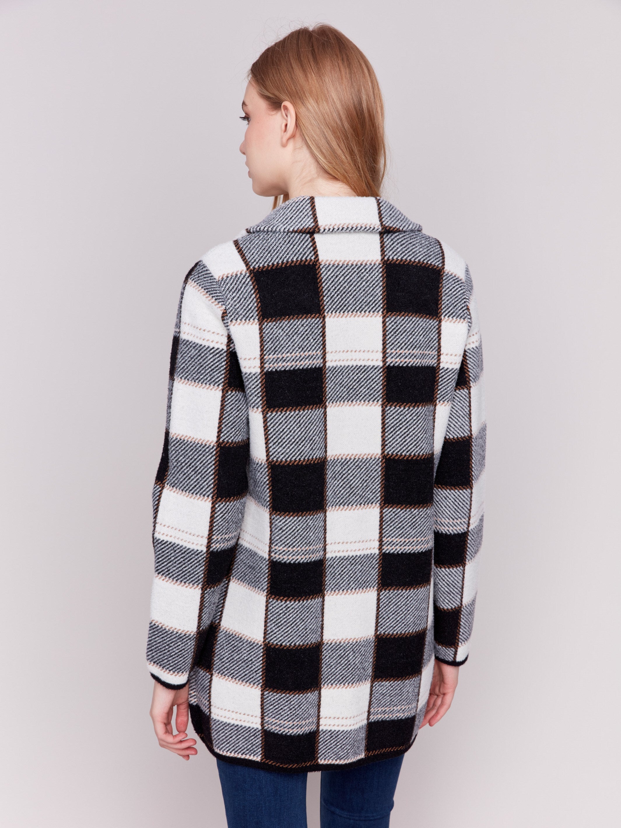 Women's plaid coat in black and white with a lapel notch collar, full button closure, and side welt pockets by Charlie B.