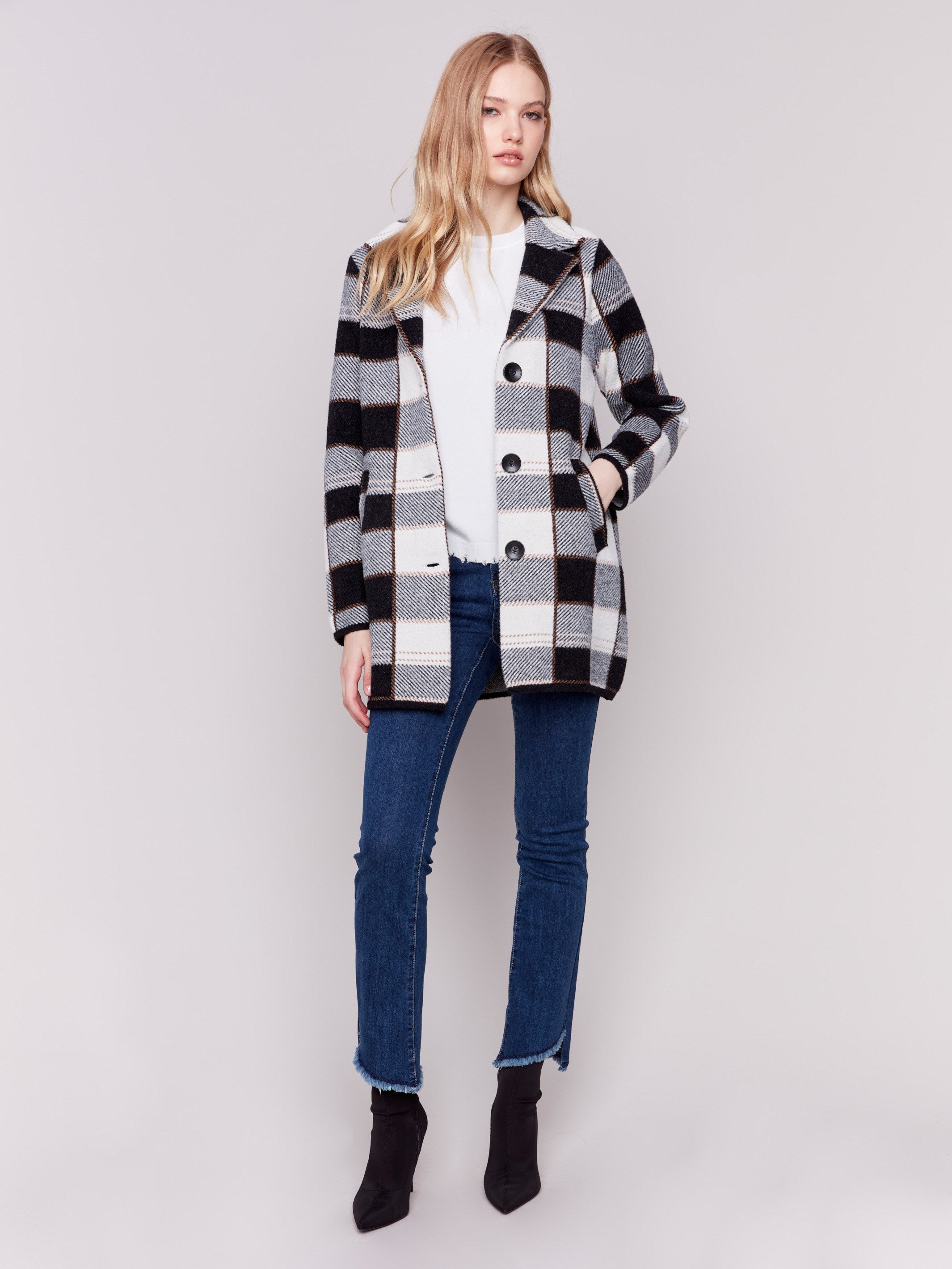 Women's plaid coat in black and white with a lapel notch collar, full button closure, and side welt pockets by Charlie B.