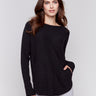 Black knit sweater with a crew neckline, long ribbed sleeves, and back lace-up eyelet details by Charlie B.