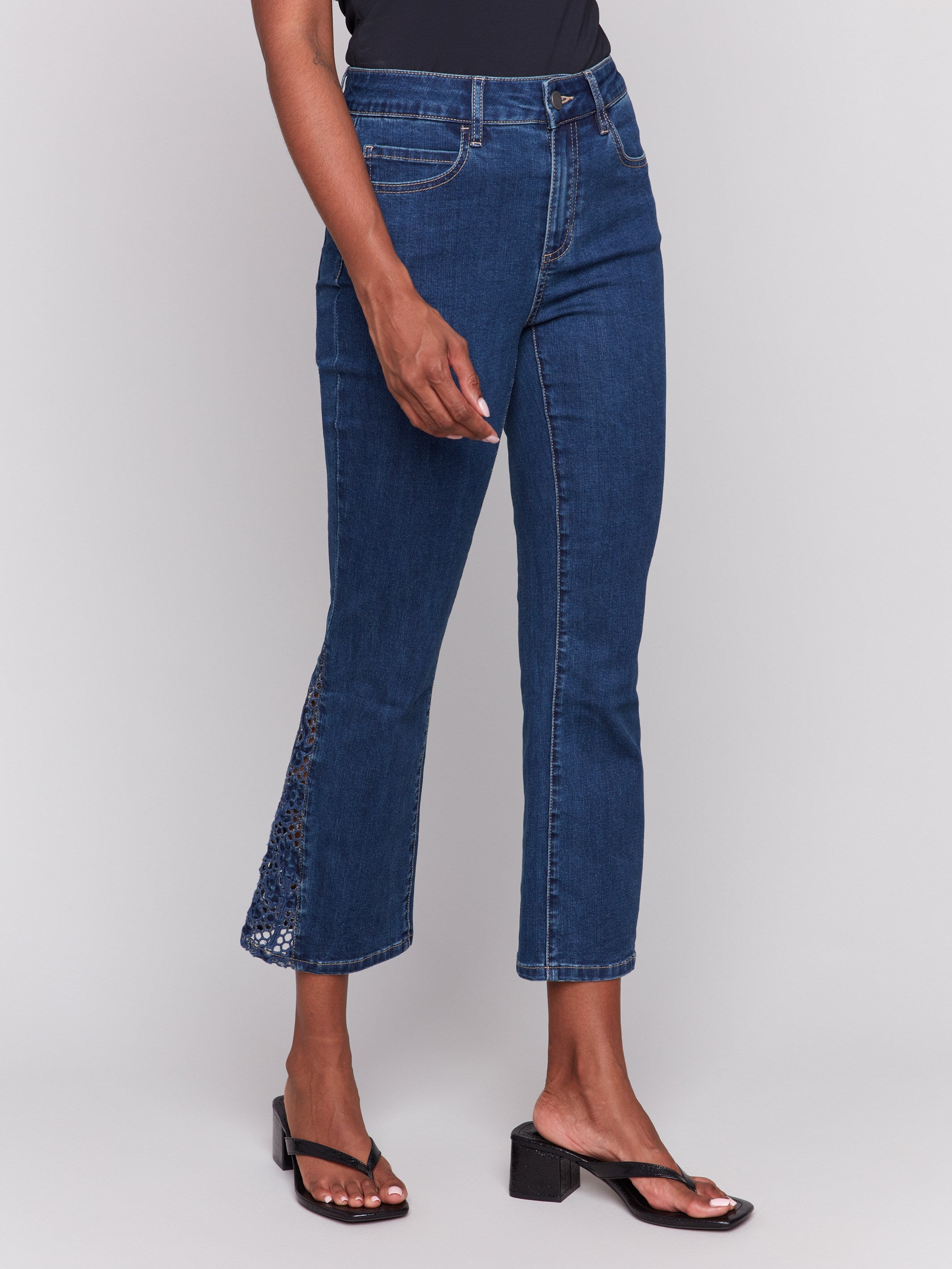 Regular rise indigo jeans with intricate lace cuts on the sides by Charlie B.