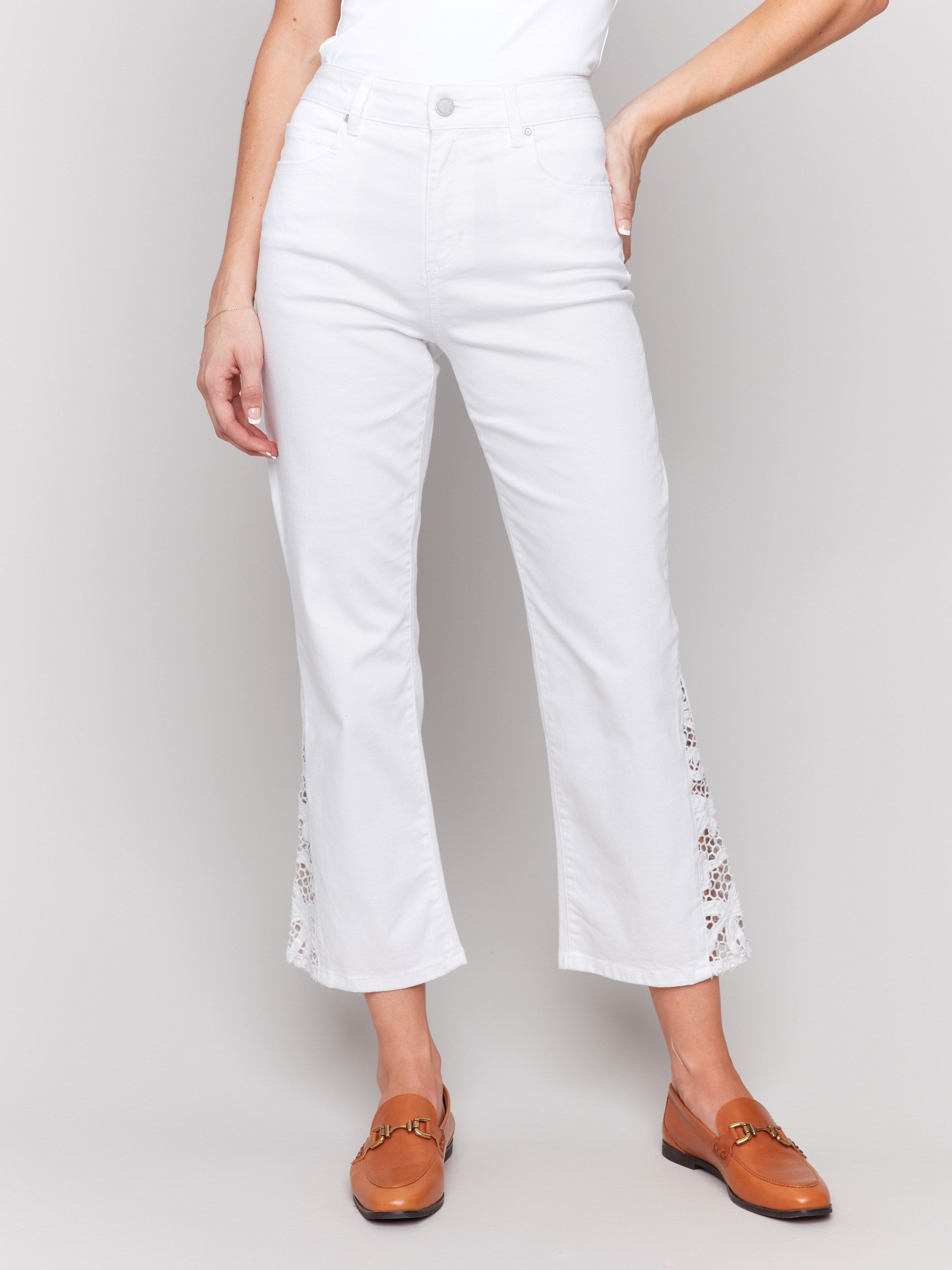 Ankle-length white pants featuring a regular rise design by Charlie B.