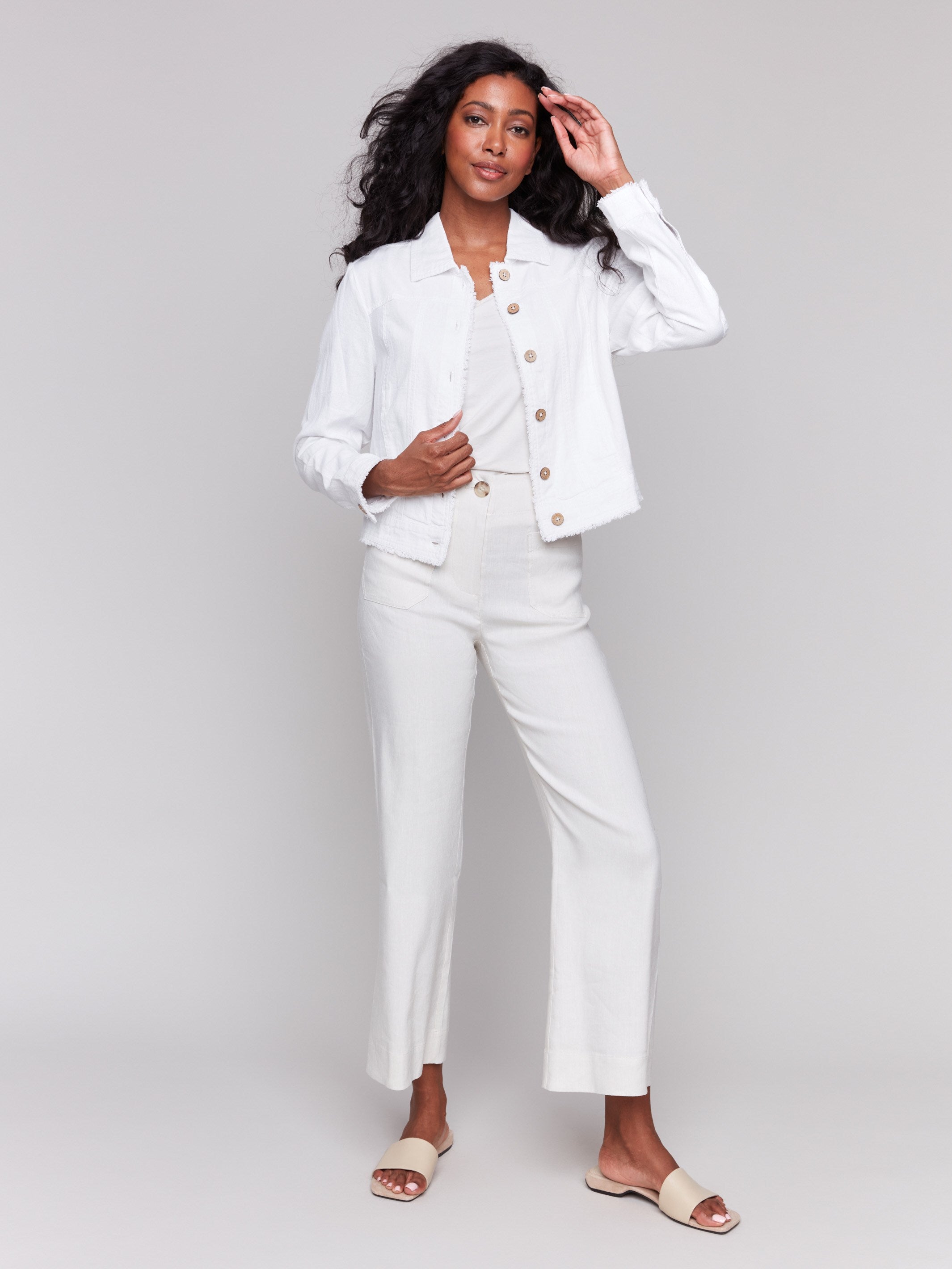 White linen blend jacket featuring short length with front pockets by Charlie B.