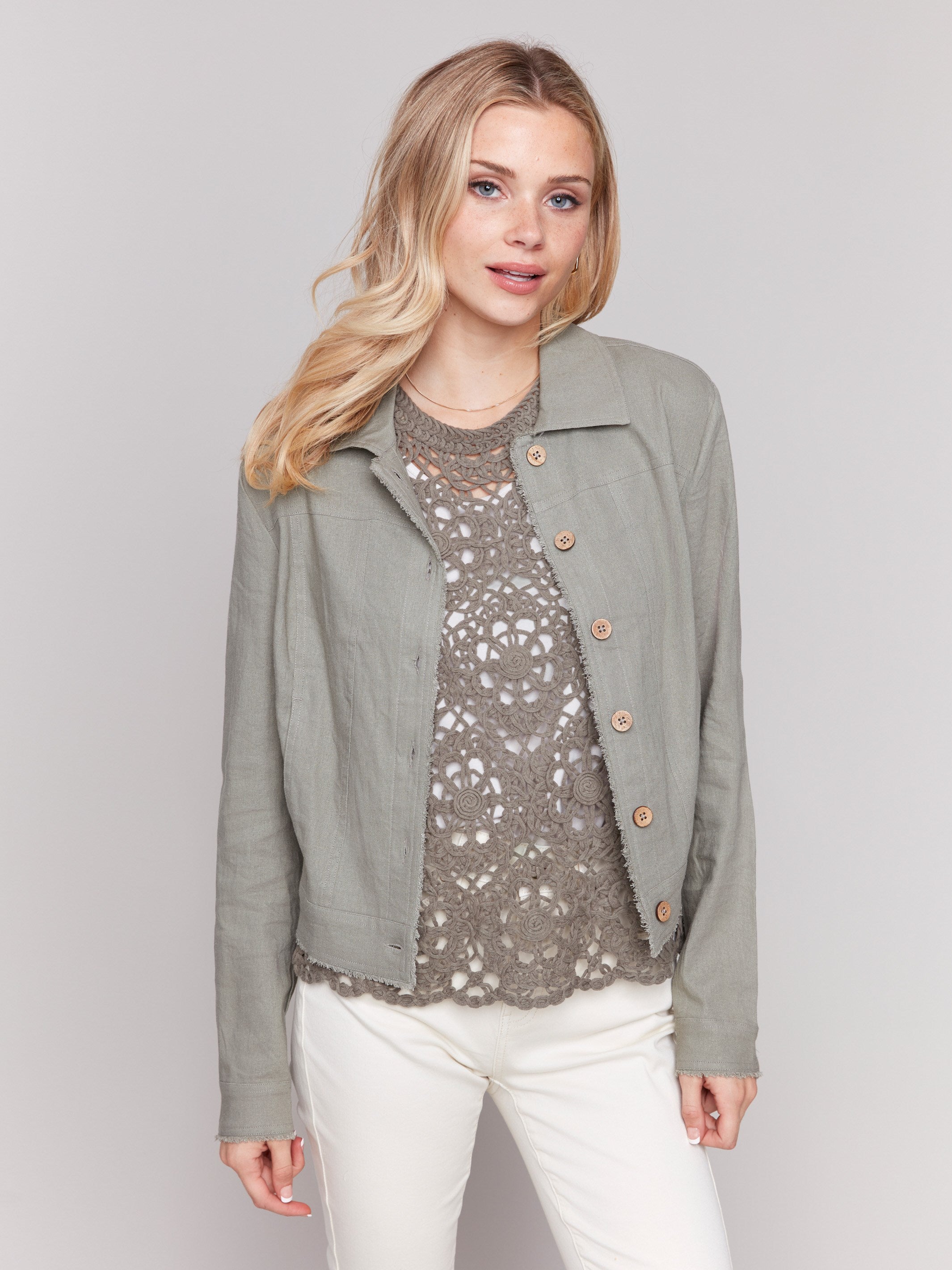 Short length linen blend jacket in celadon with distinctive buttons closure by Charlie B.