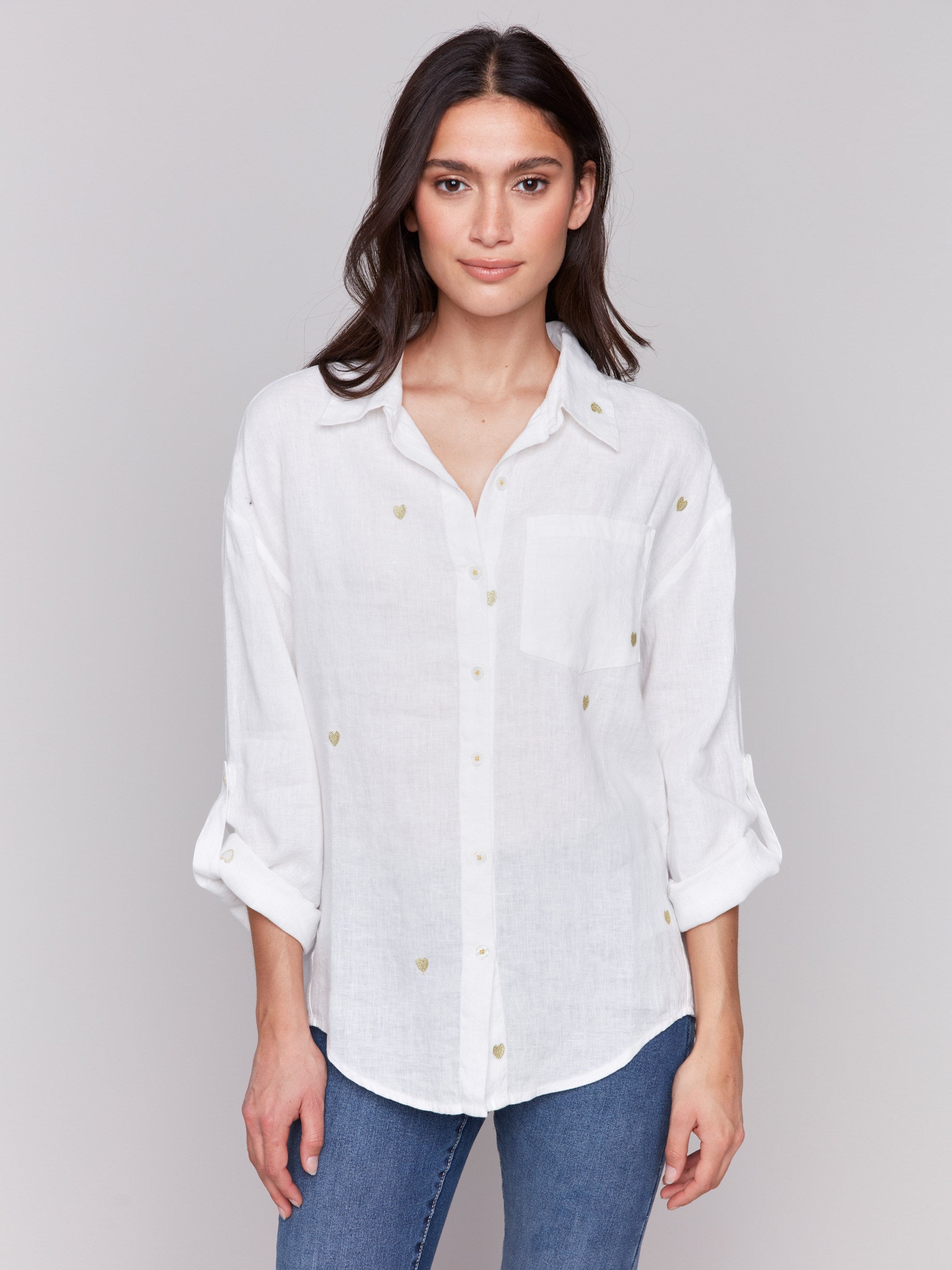 Gold linen tunic blouse with embroidered hearts, featuring a long button-down design, drop shoulders, and roll-up sleeves by Charlie B.