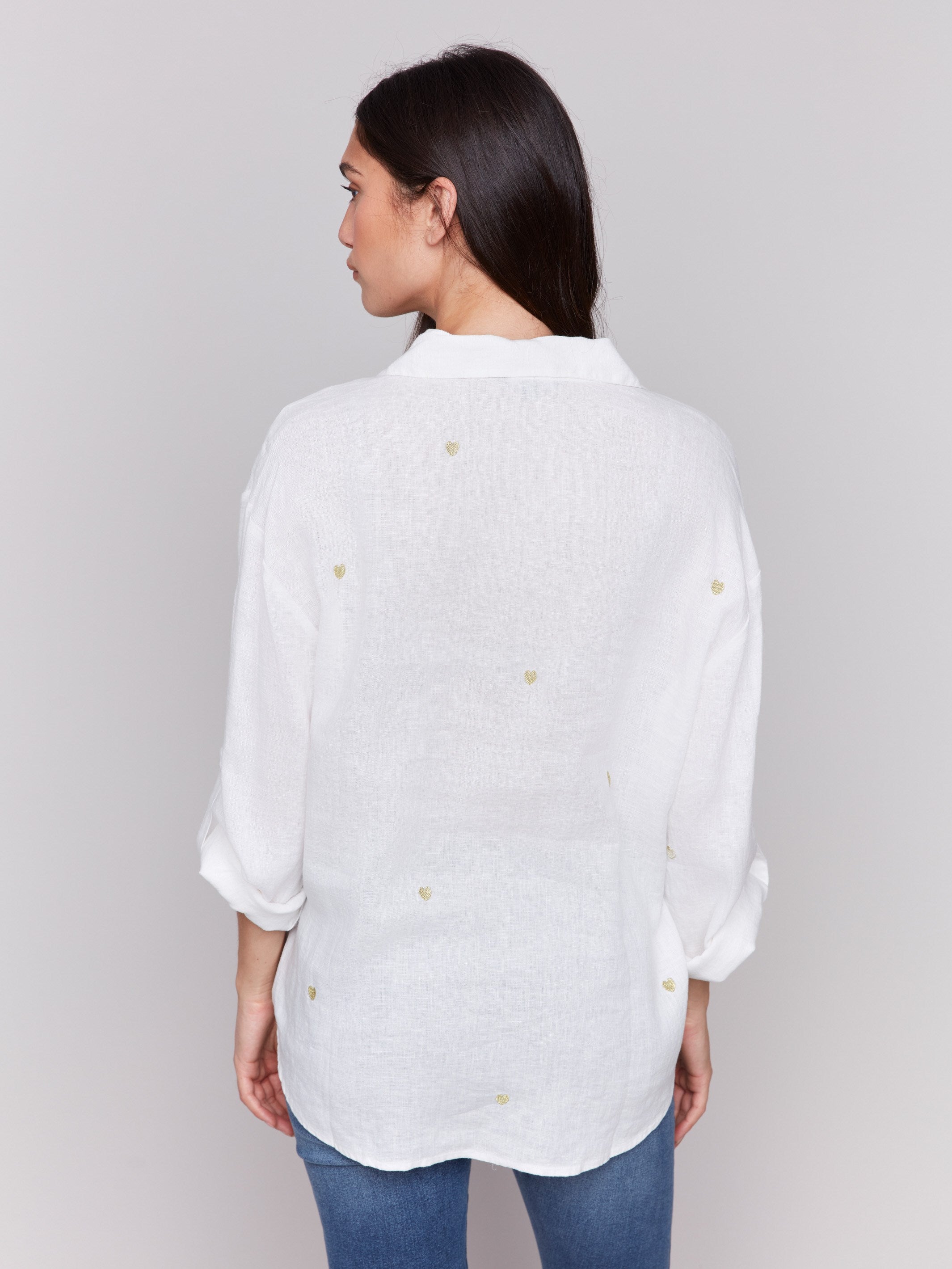 Gold linen tunic blouse with embroidered hearts, featuring a long button-down design, drop shoulders, and roll-up sleeves by Charlie B.