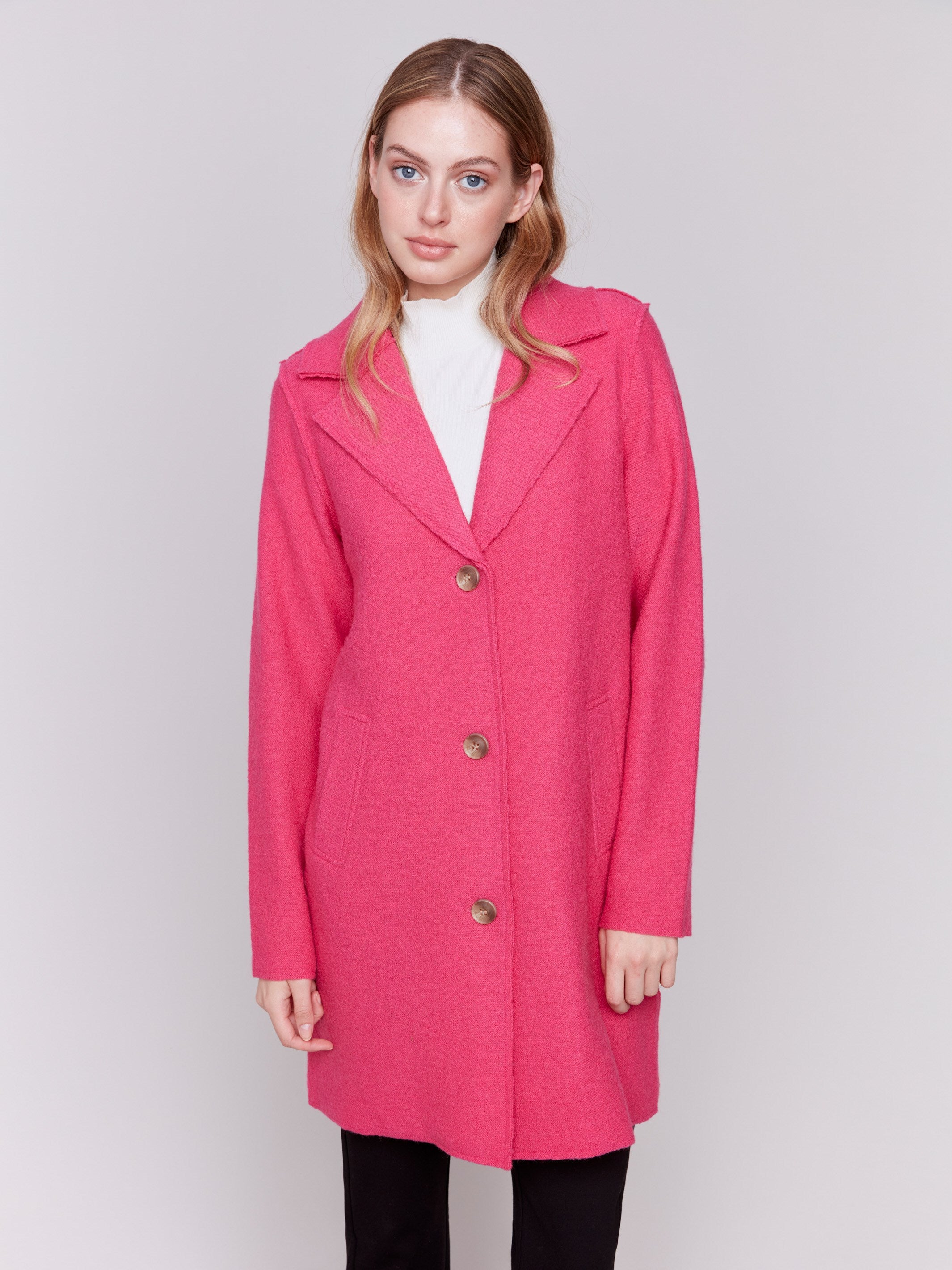 Magenta pink long wool coat with lapel notch collar and button closures, featuring front welt pockets by Charlie B.