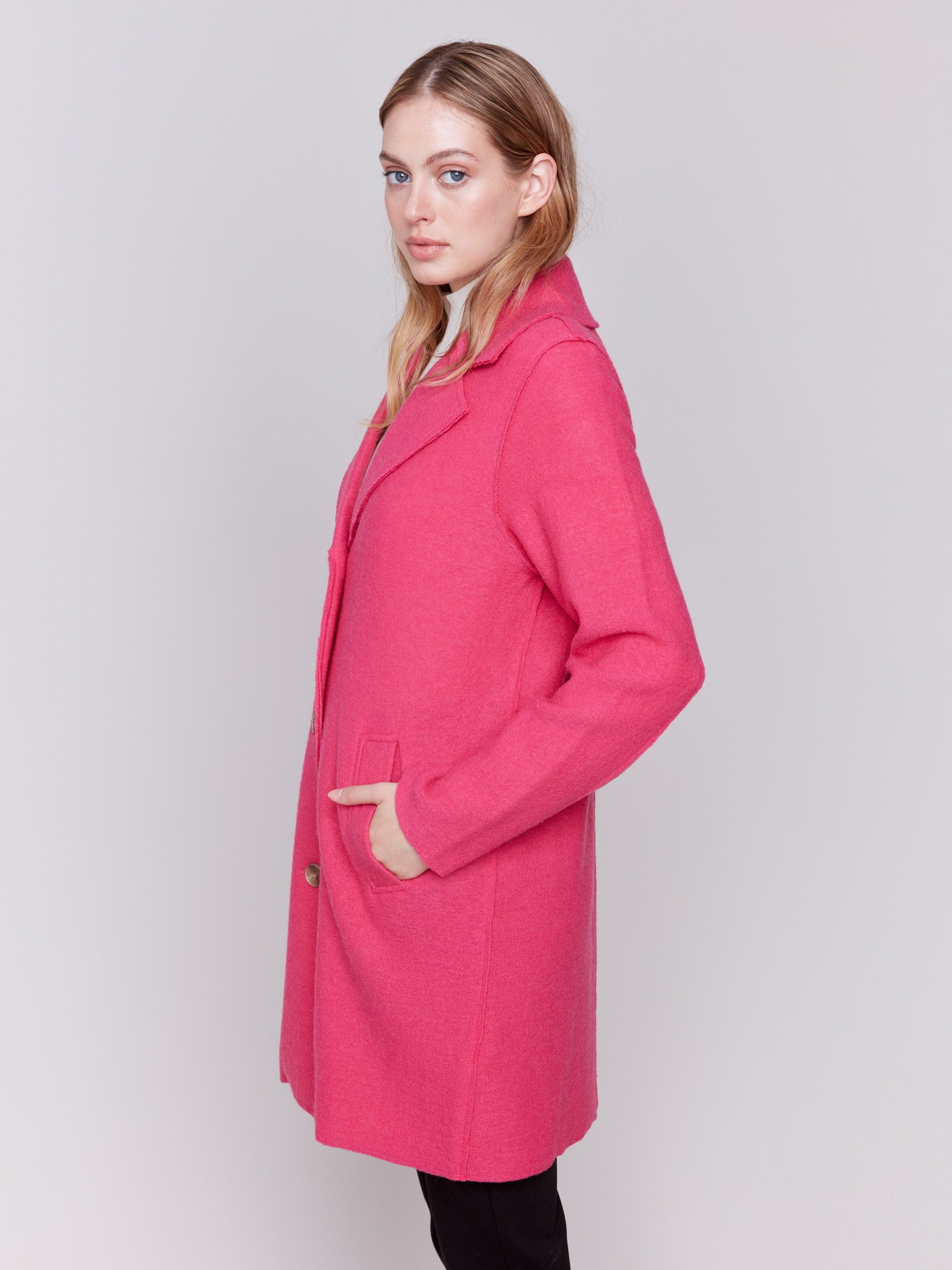 Magenta pink long wool coat with lapel notch collar and button closures, featuring front welt pockets by Charlie B.