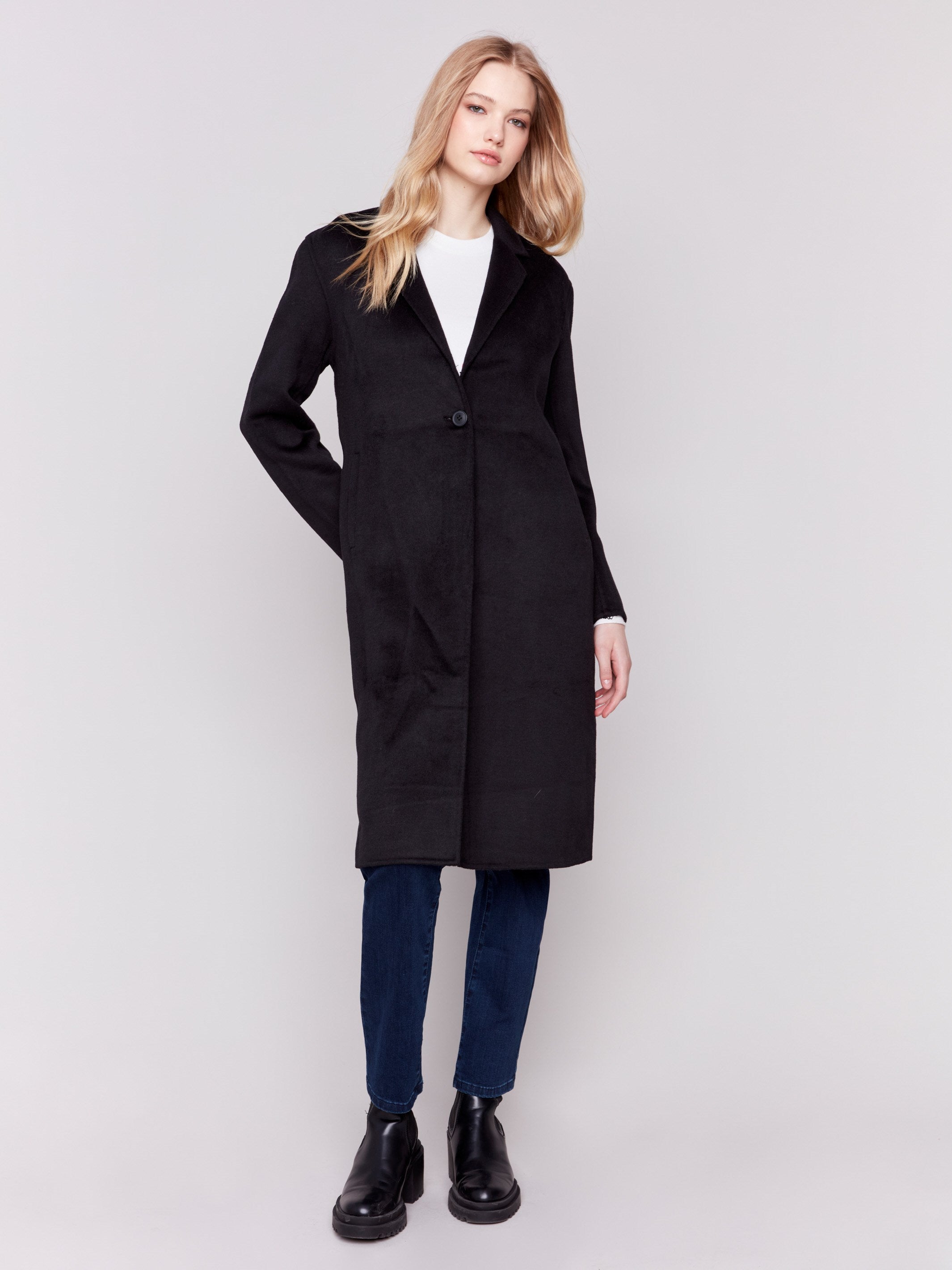 Black long double-faced wool coat with a minimalist design, single-breasted front, and sleek button closure by Charlie B.