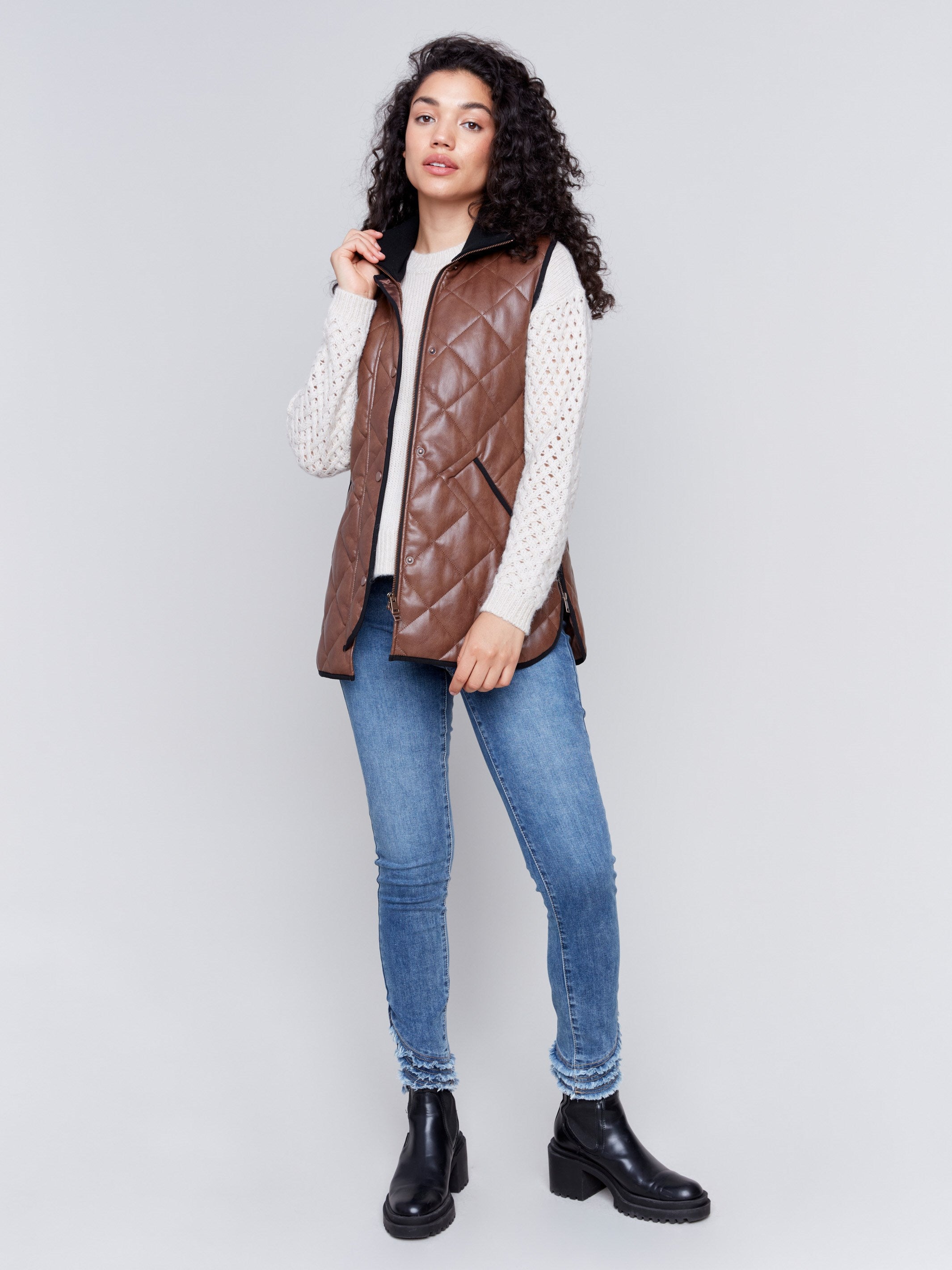 Brown faux leather vest with quilted design, featuring a front zipper closure and side welt pockets, by Charlie B.