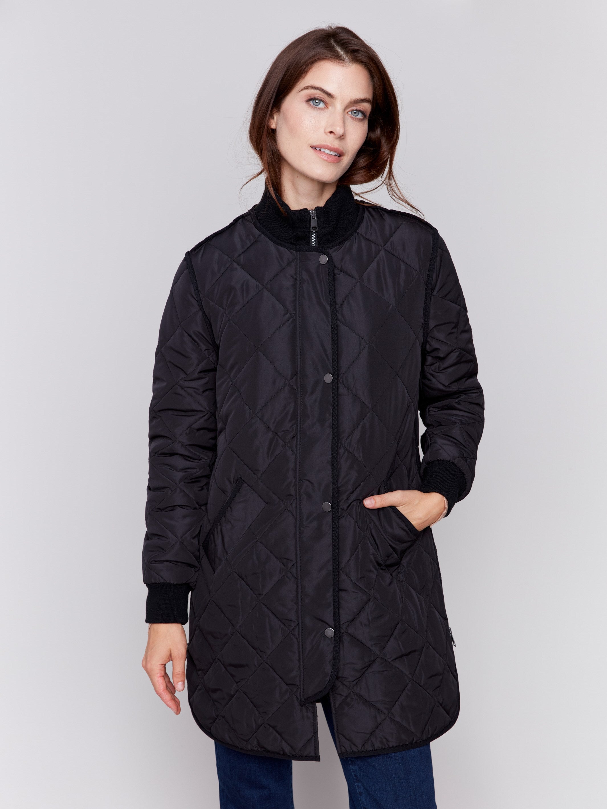 Black long quilted puffer jacket with rib knit detail, zipper front, and front pockets by Charlie B.