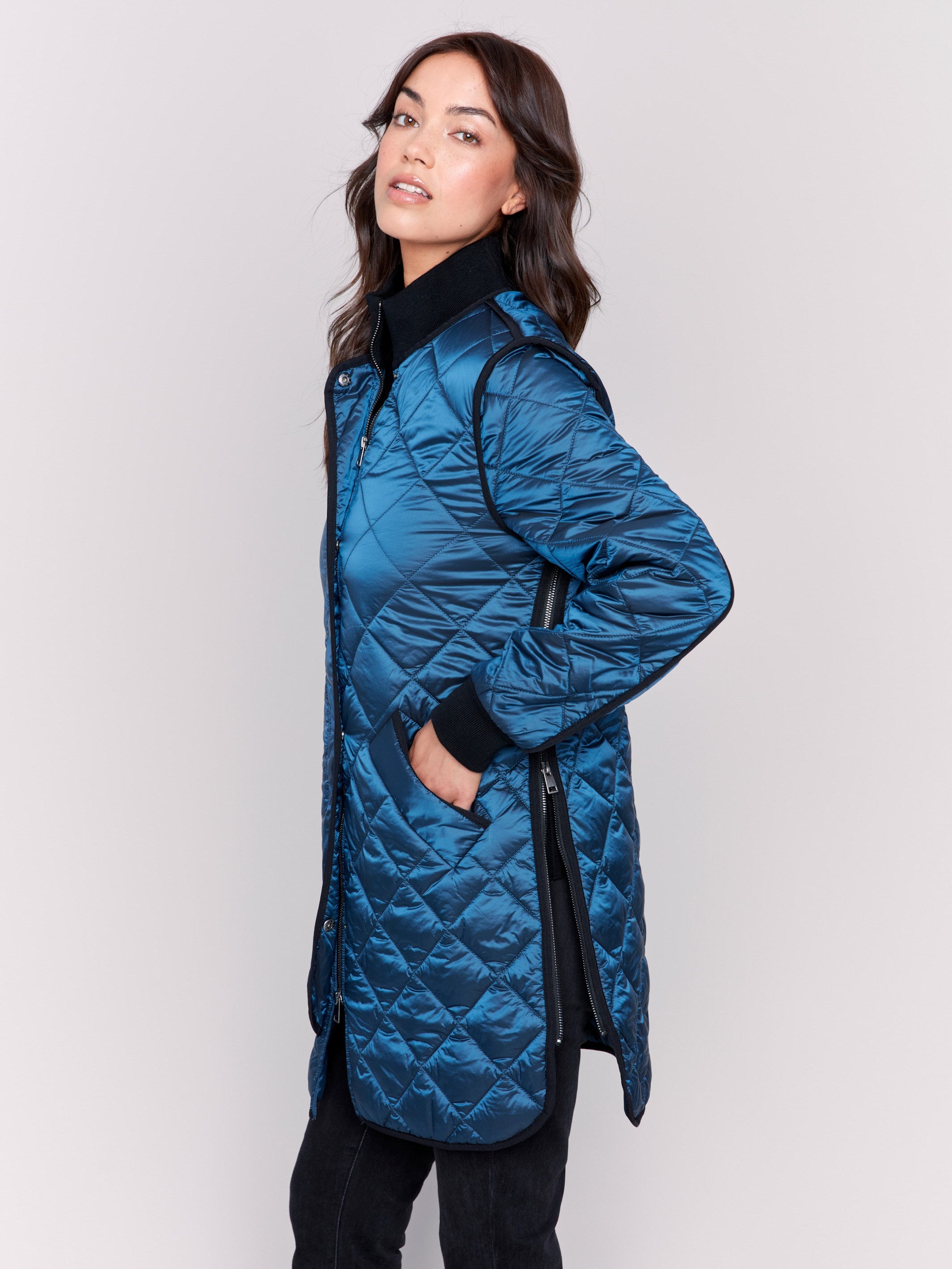 Long blue quilted puffer jacket with zipper front and rib knit collar and cuffs by Charlie B.