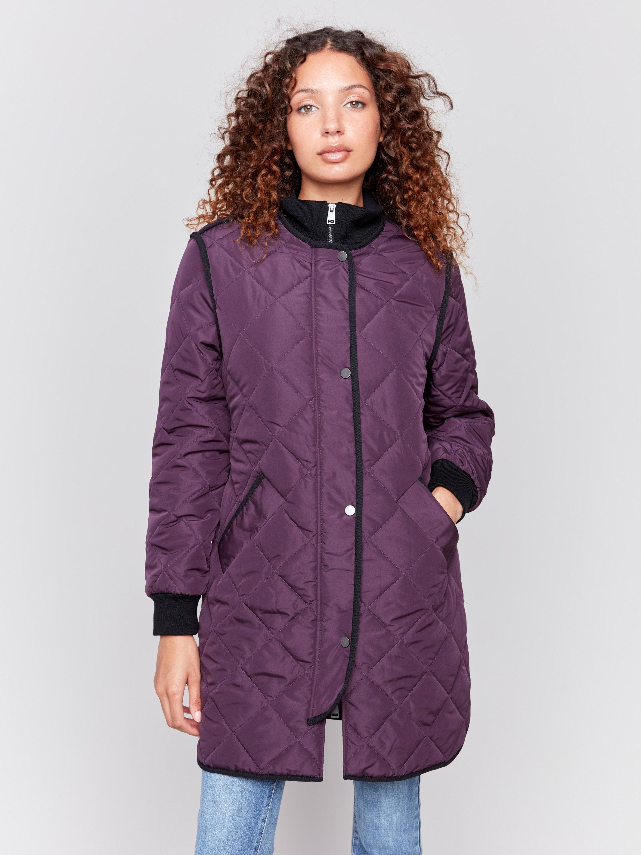 Plum purple long quilted puffer jacket with rib knit detail, zipper front, and front pockets by Charlie B.