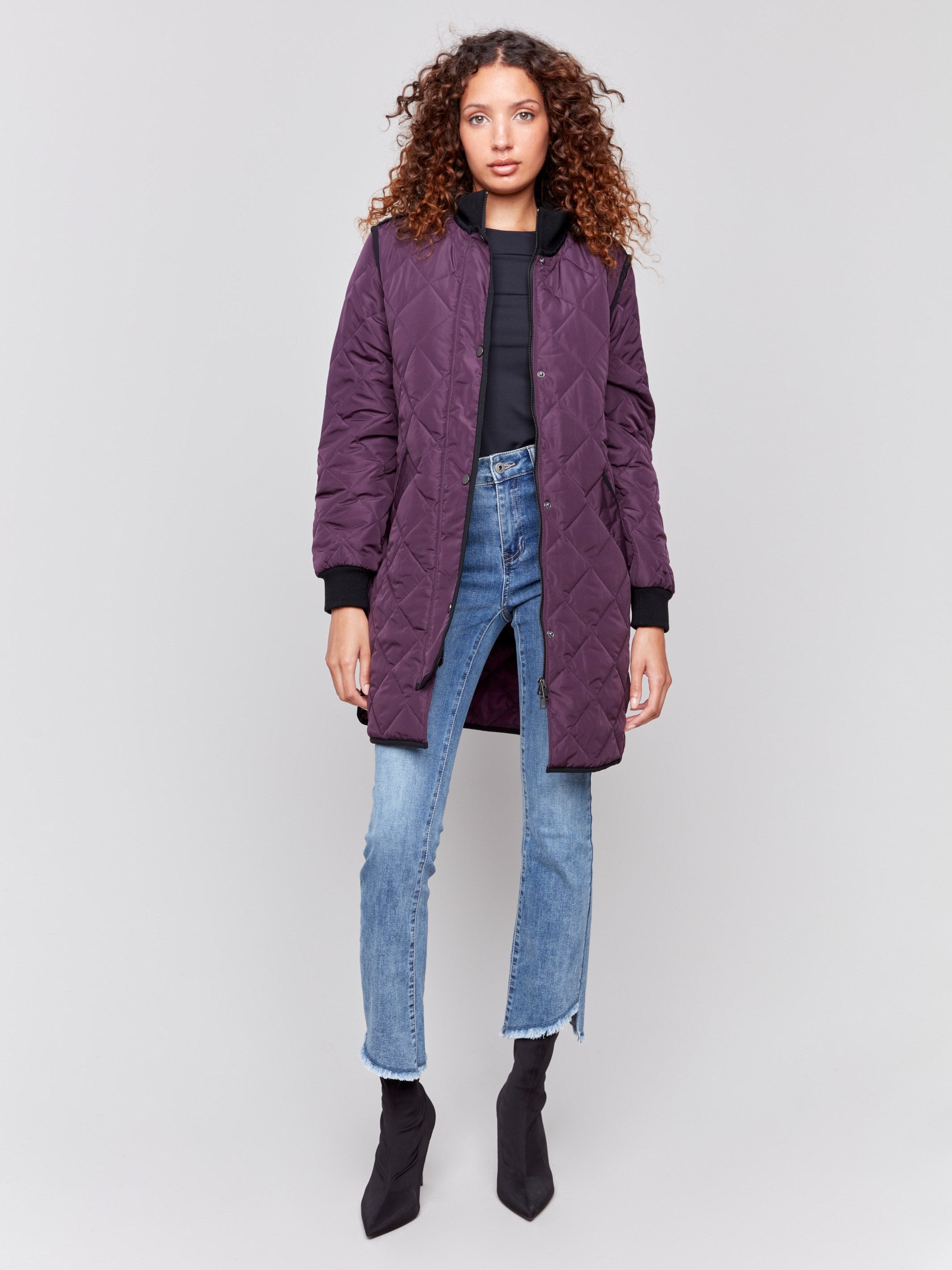 Plum purple long quilted puffer jacket with rib knit detail, zipper front, and front pockets by Charlie B.