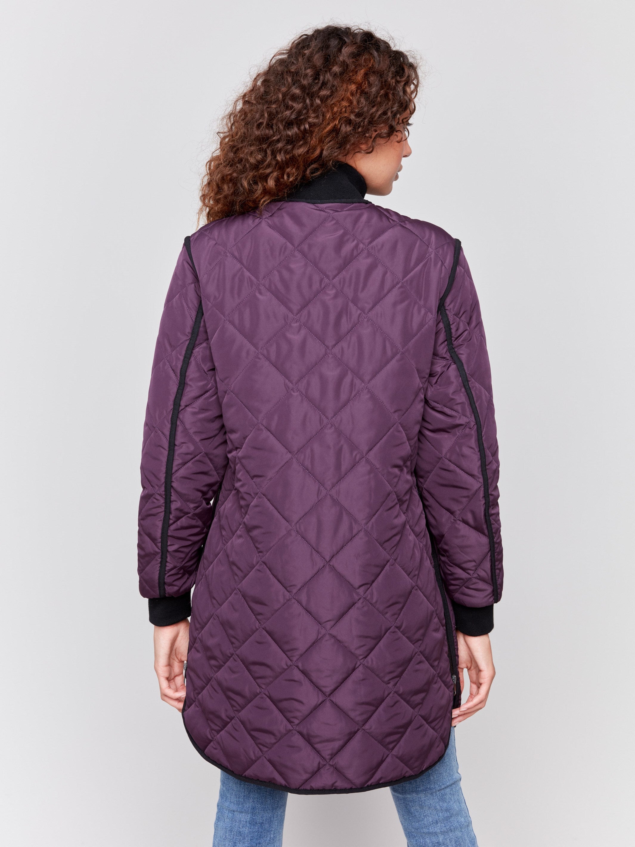 Plum purple long quilted puffer jacket with rib knit detail, zipper front, and front pockets by Charlie B.