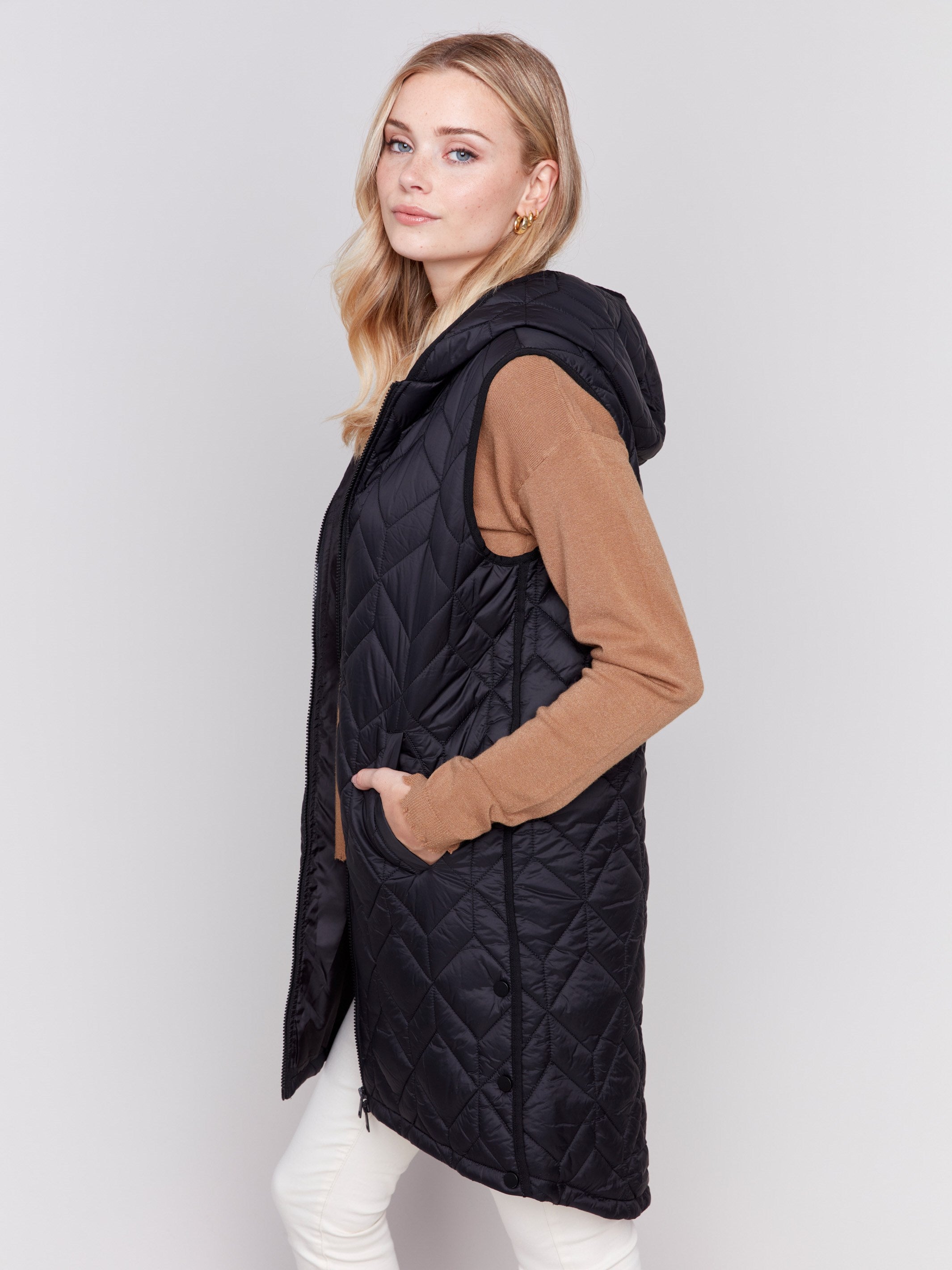 Black long quilted puffer vest with zip closure and hood by Charlie B.