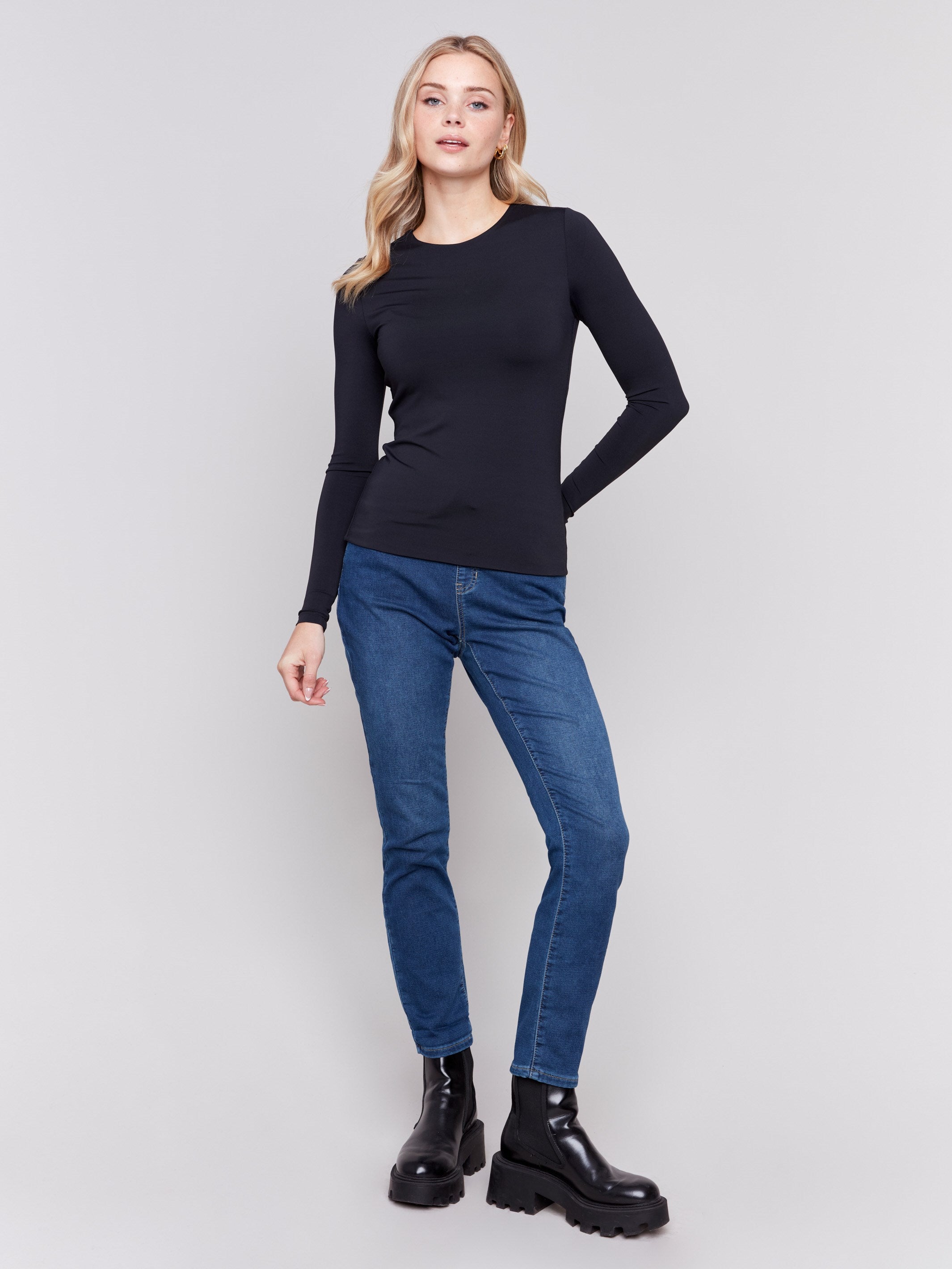 Black long-sleeve top with crew neckline, featuring a fitted silhouette by Charlie B.