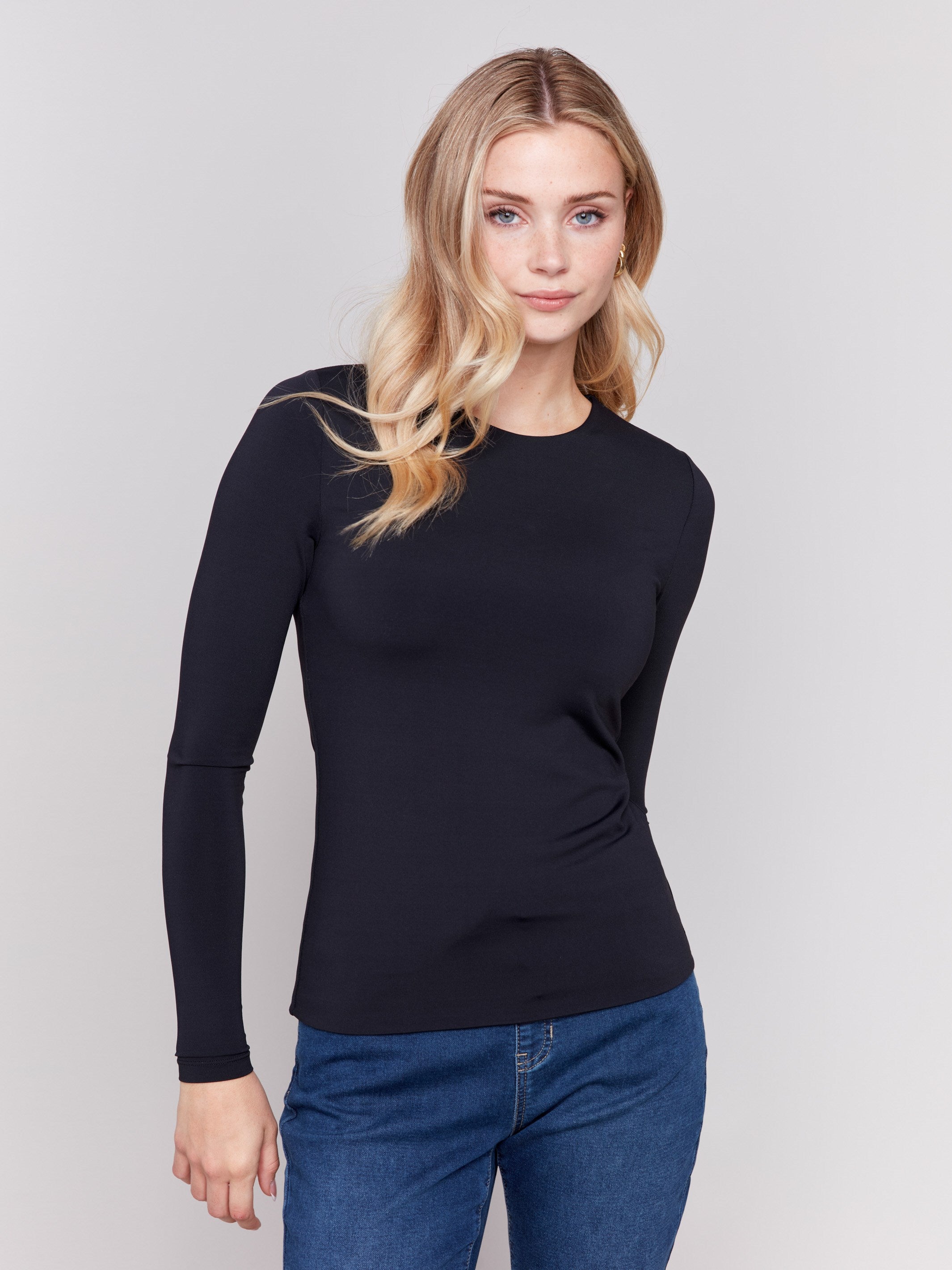 Black long-sleeve top with crew neckline, featuring a fitted silhouette by Charlie B.