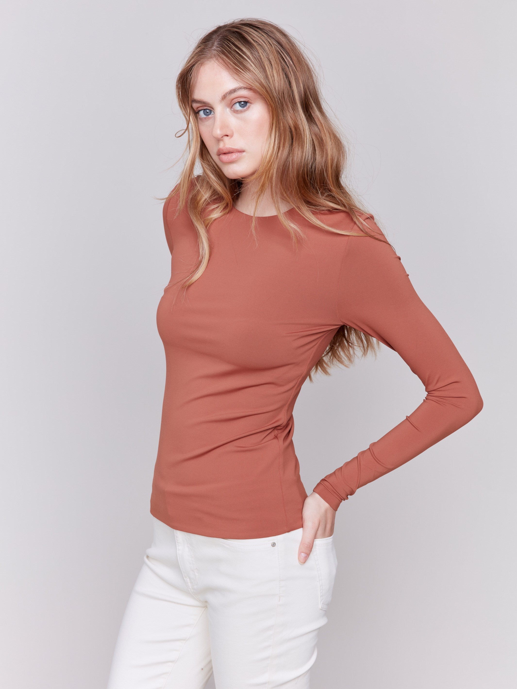 Terracotta long-sleeve top with crew neckline, featuring a fitted silhouette by Charlie B.