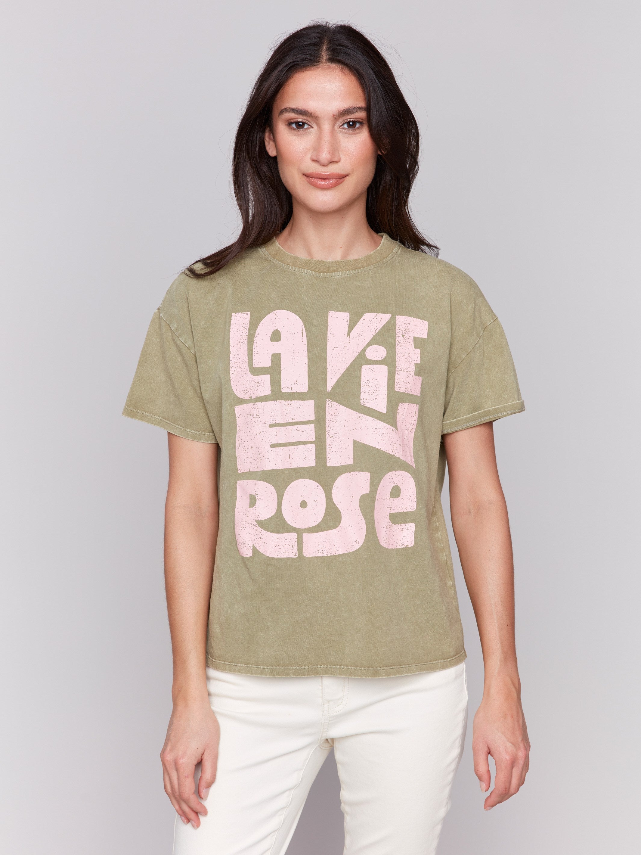 Celadon green t-shirt with a crew neckline, featuring a pink graphic by Charlie B.