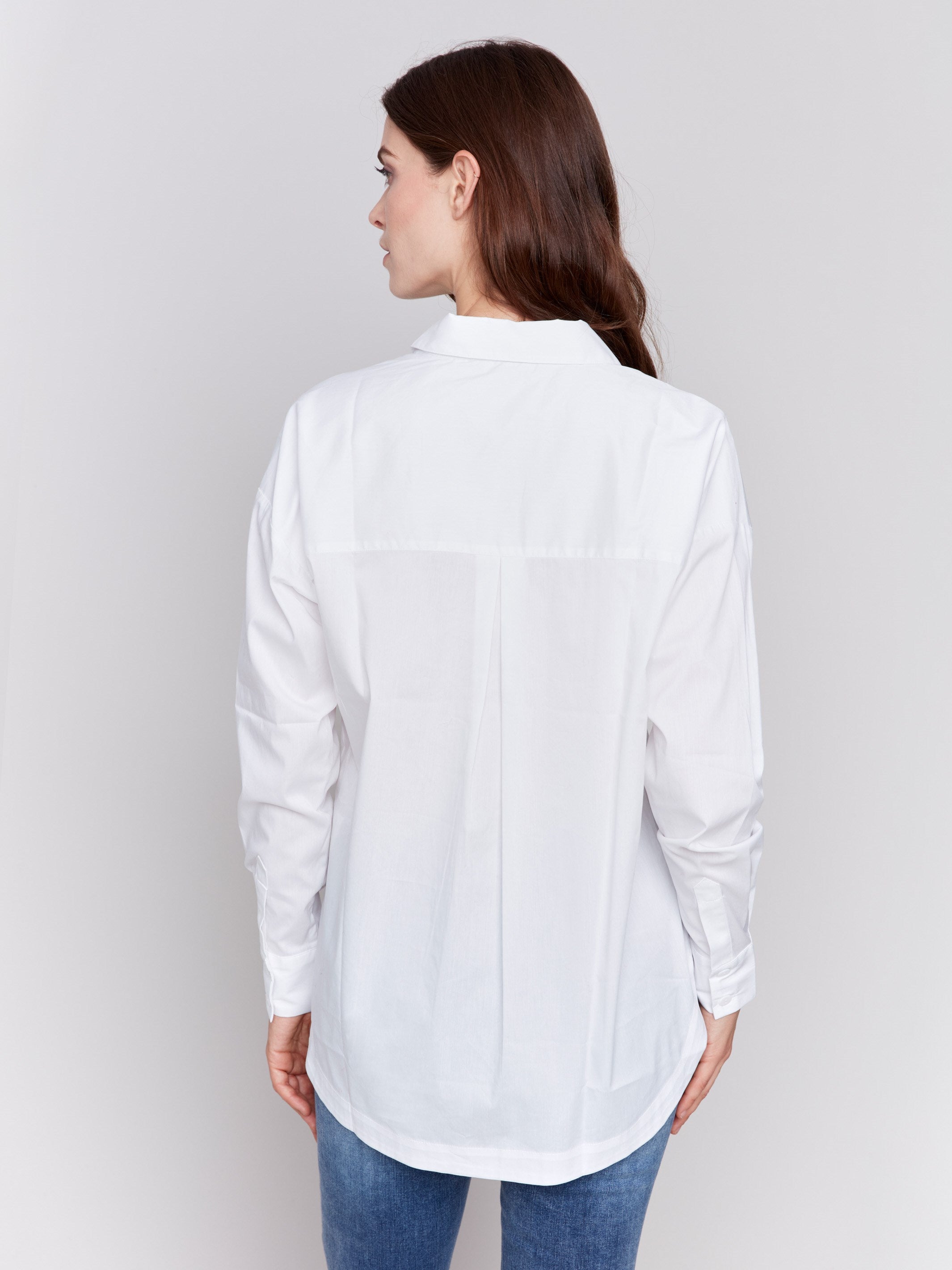 White loose fit poplin shirt with drop shoulders, rounded hem, and patch pockets by Charlie B.