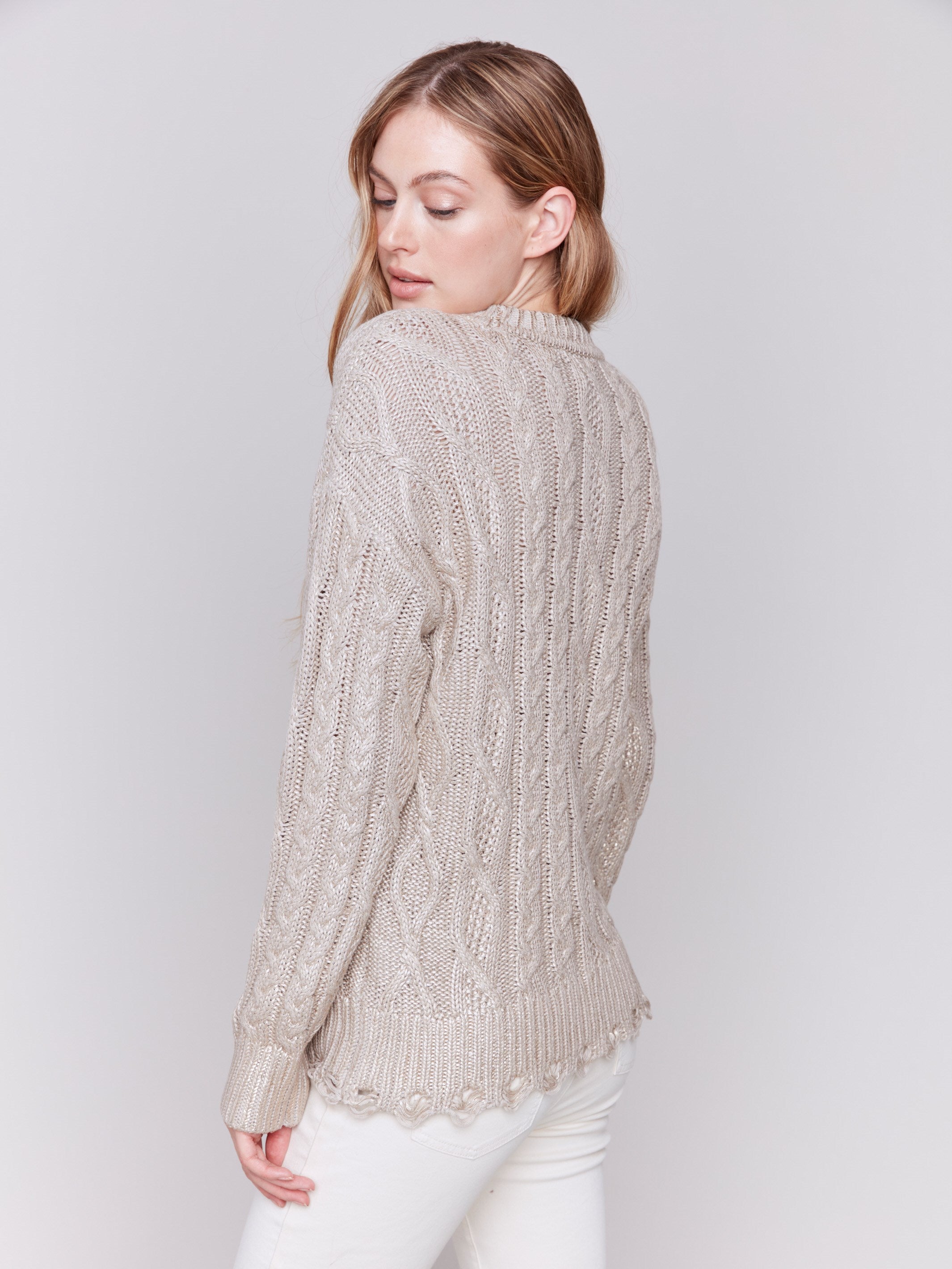 Champagne colored metallic cable knit sweater with a crew neck and long sleeves by Charlie B.