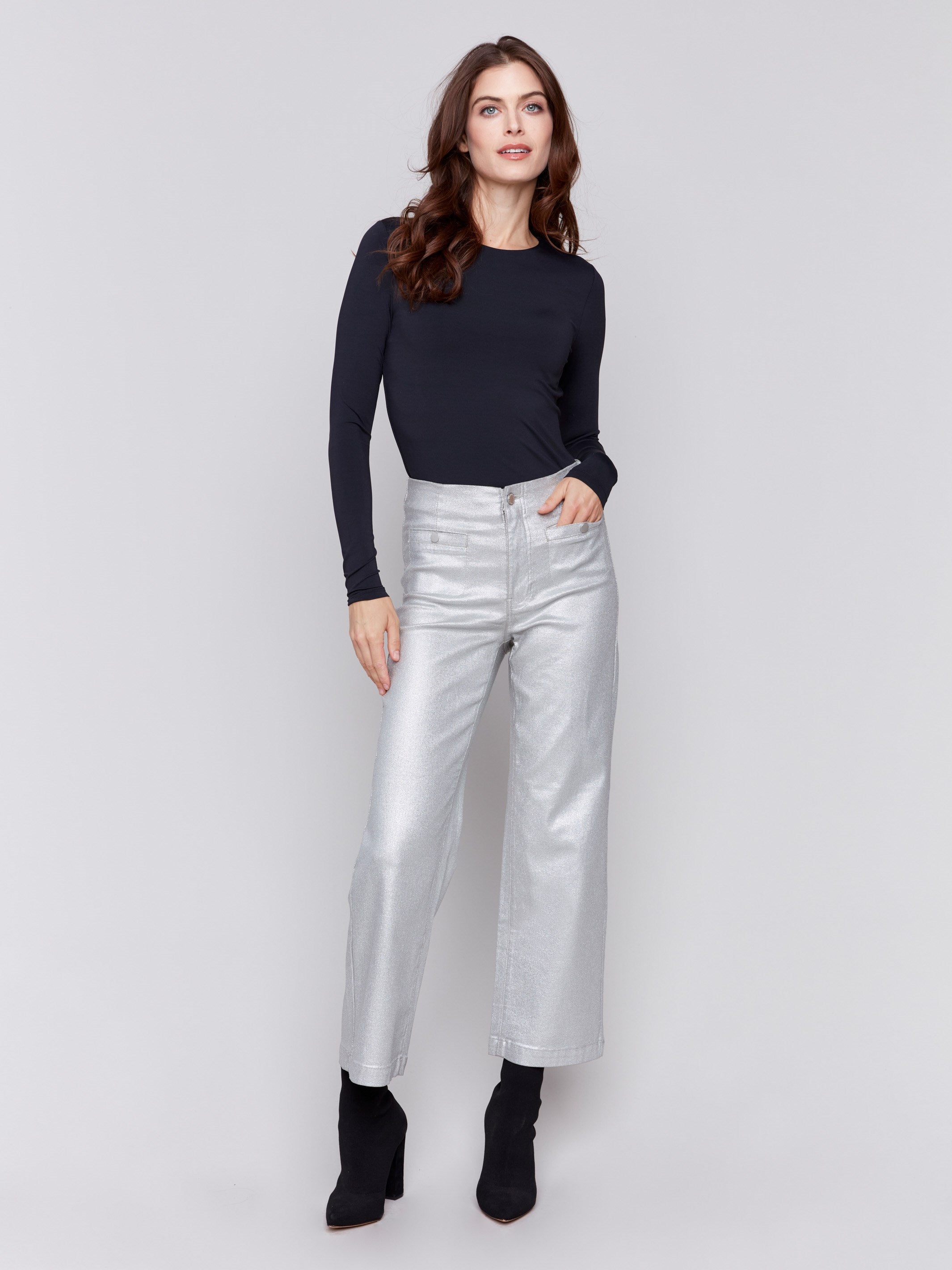 Silver metallic flared pants with welt front pockets and zipper closure by Charlie B.