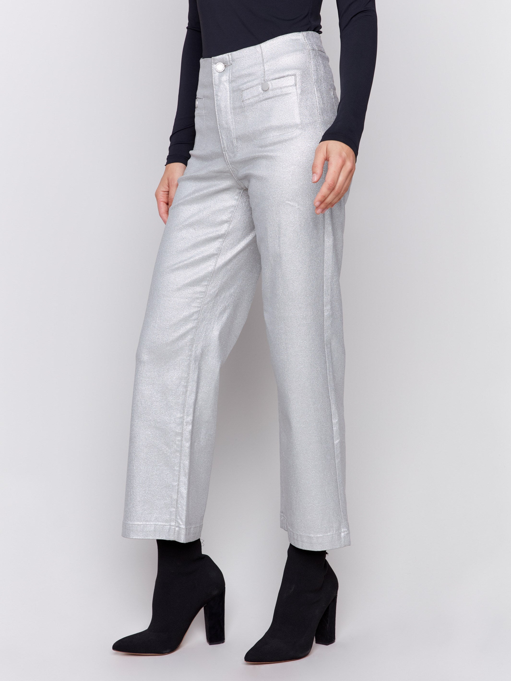 Silver metallic flared pants with welt front pockets and zipper closure by Charlie B.