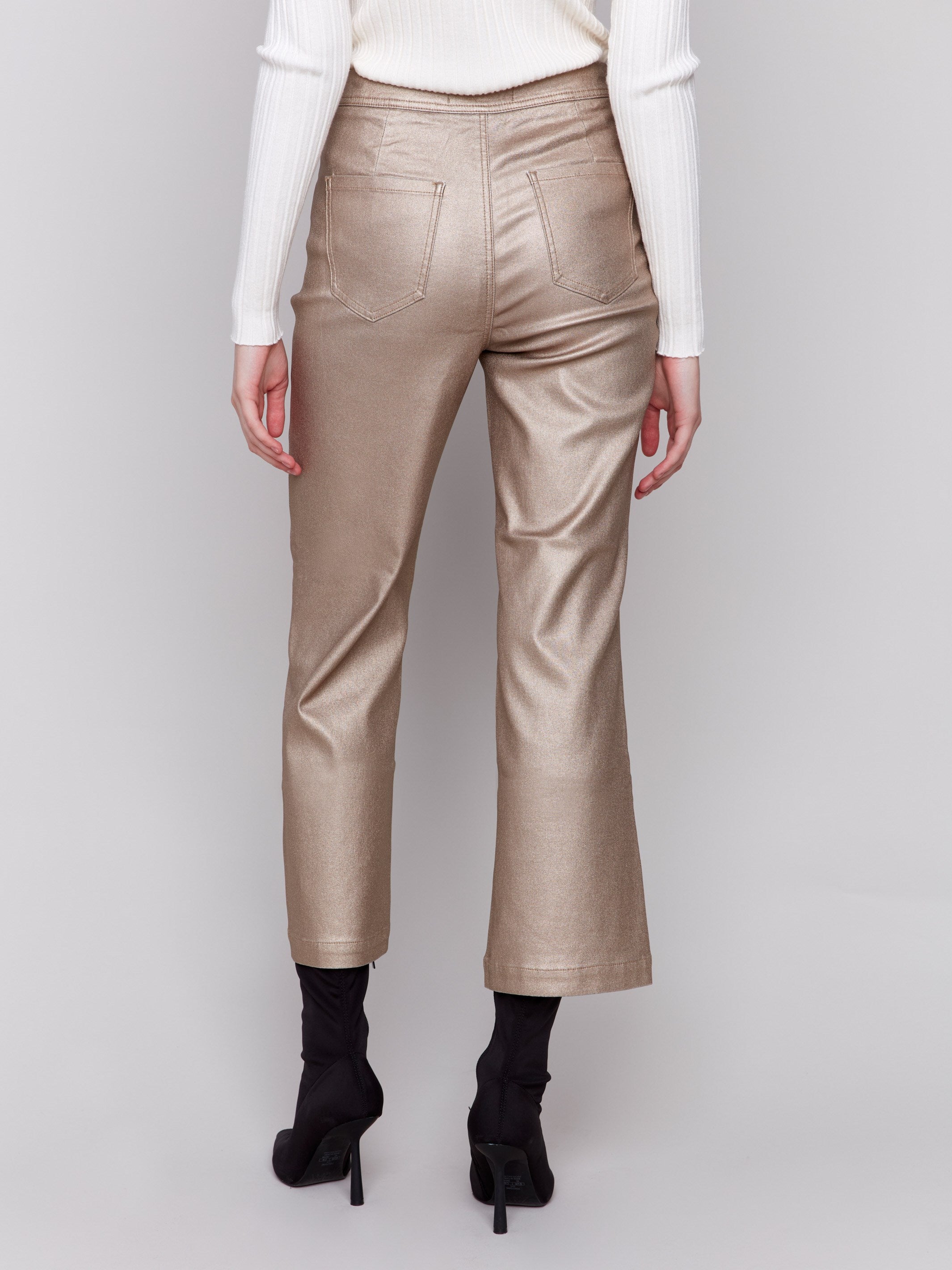 Bronze metallic flared pants with welt front pockets and zipper closure by Charlie B.